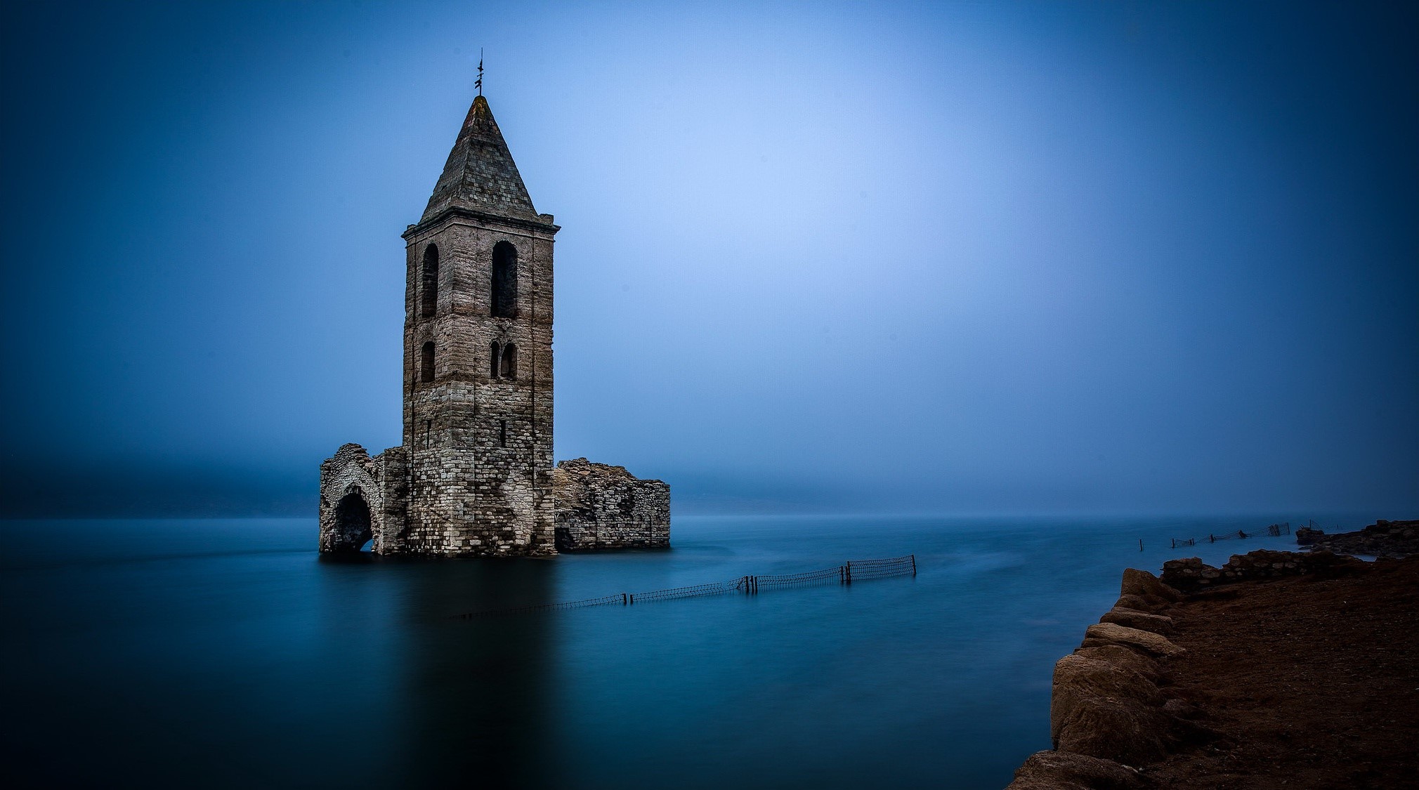 Ruined church tower submerged in water HD Wallpaper