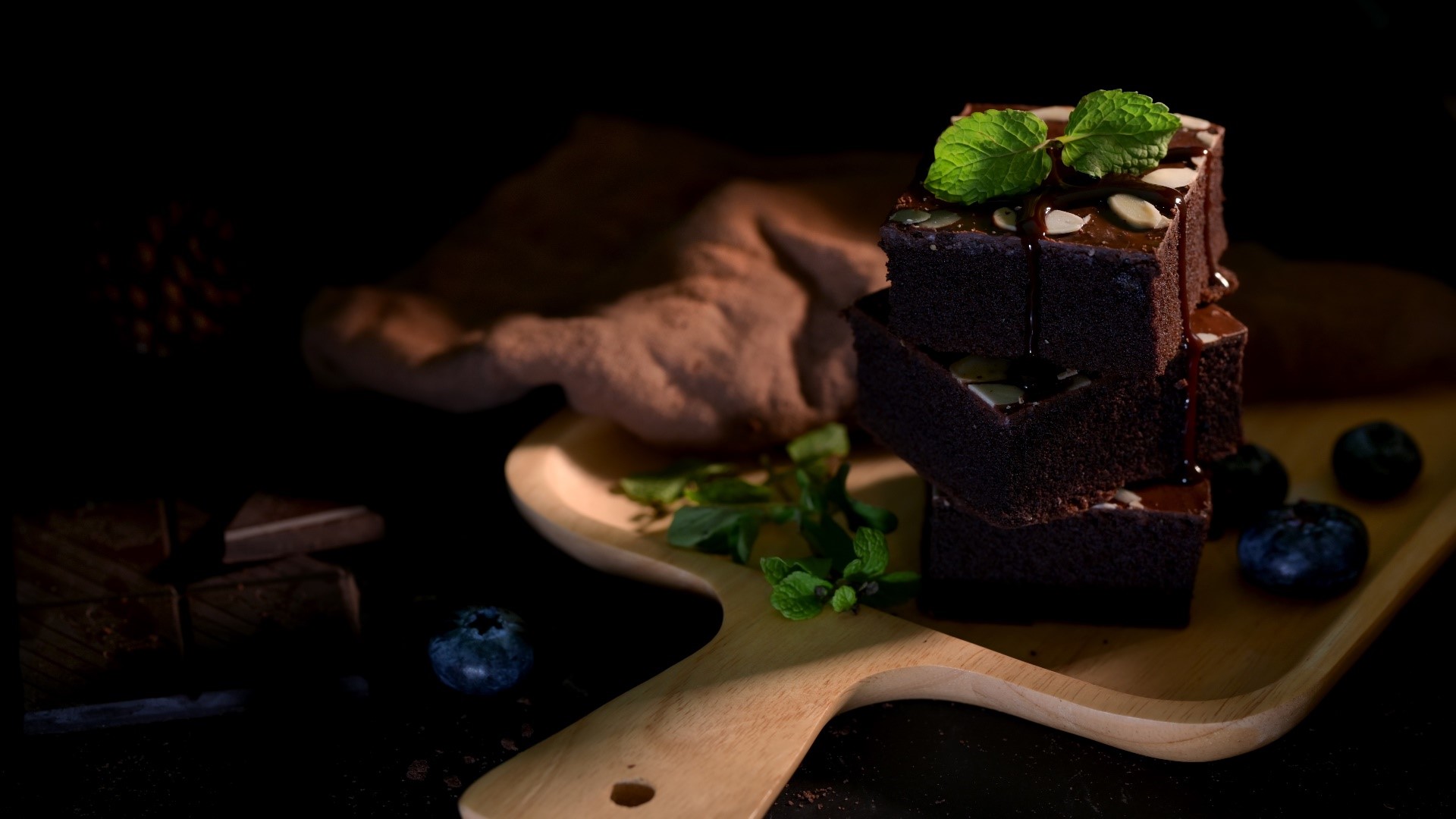 Stack of chocolate brownies with mint and blueberries HD Wallpaper