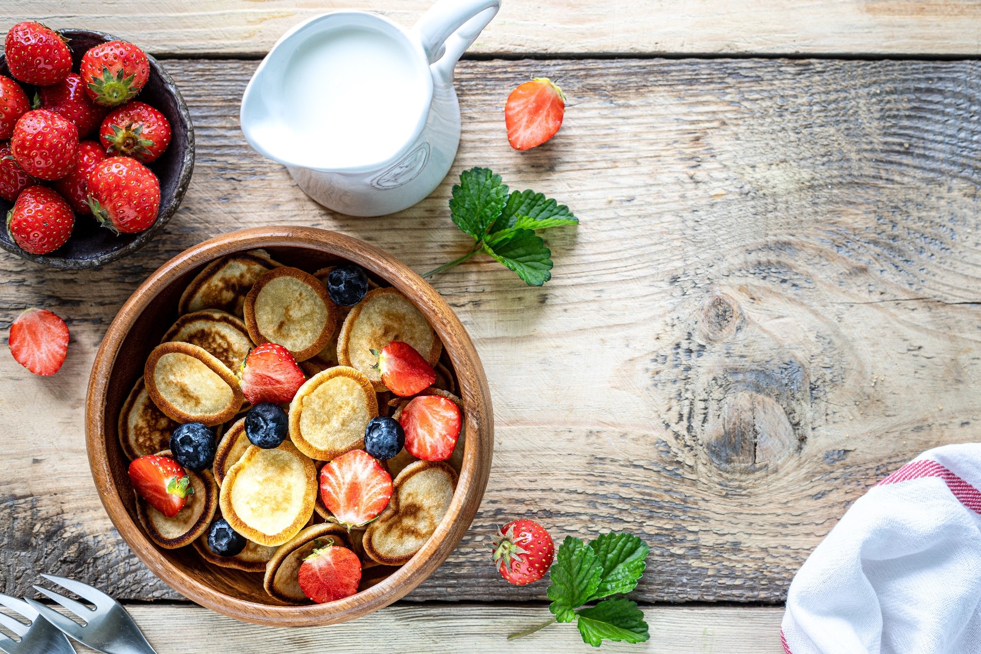 Mini pancakes with strawberries and blueberries and a jug of milk HD Wallpaper