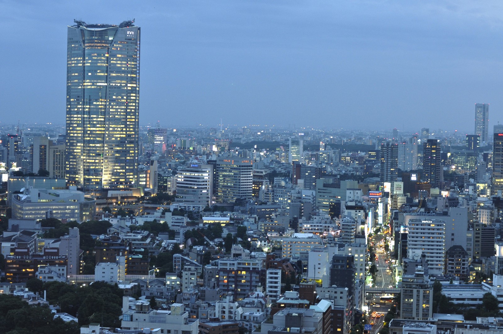 Cityscape with illuminated skyscrapers at dusk HD Wallpaper