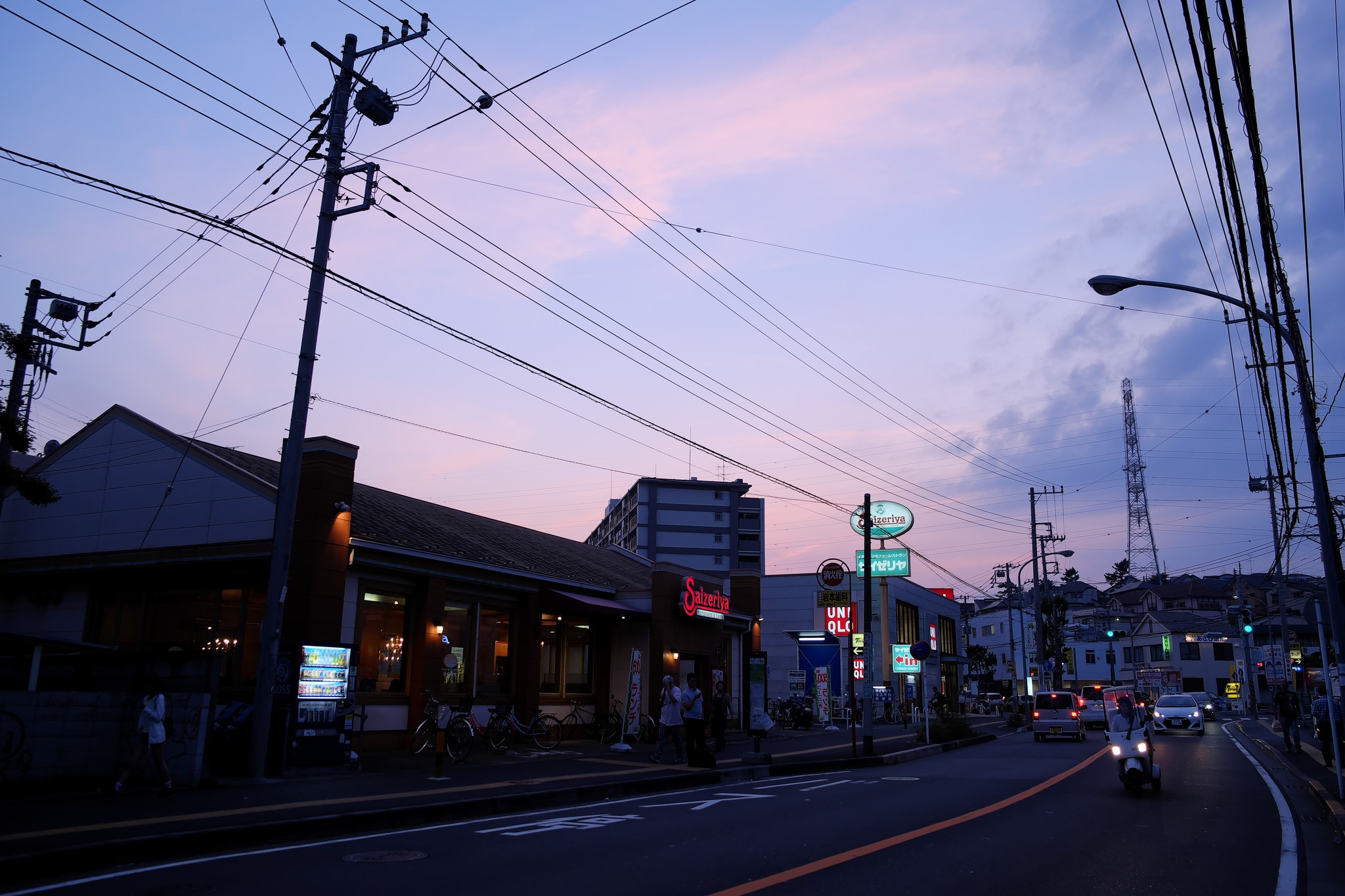 Street scene at dusk with power lines and shops HD Wallpaper