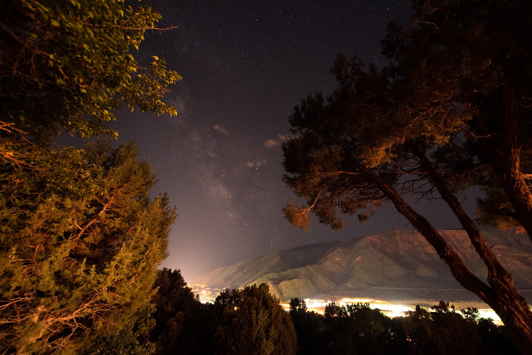 Night landscape with Milky Way over mountains and city lights HD Wallpaper