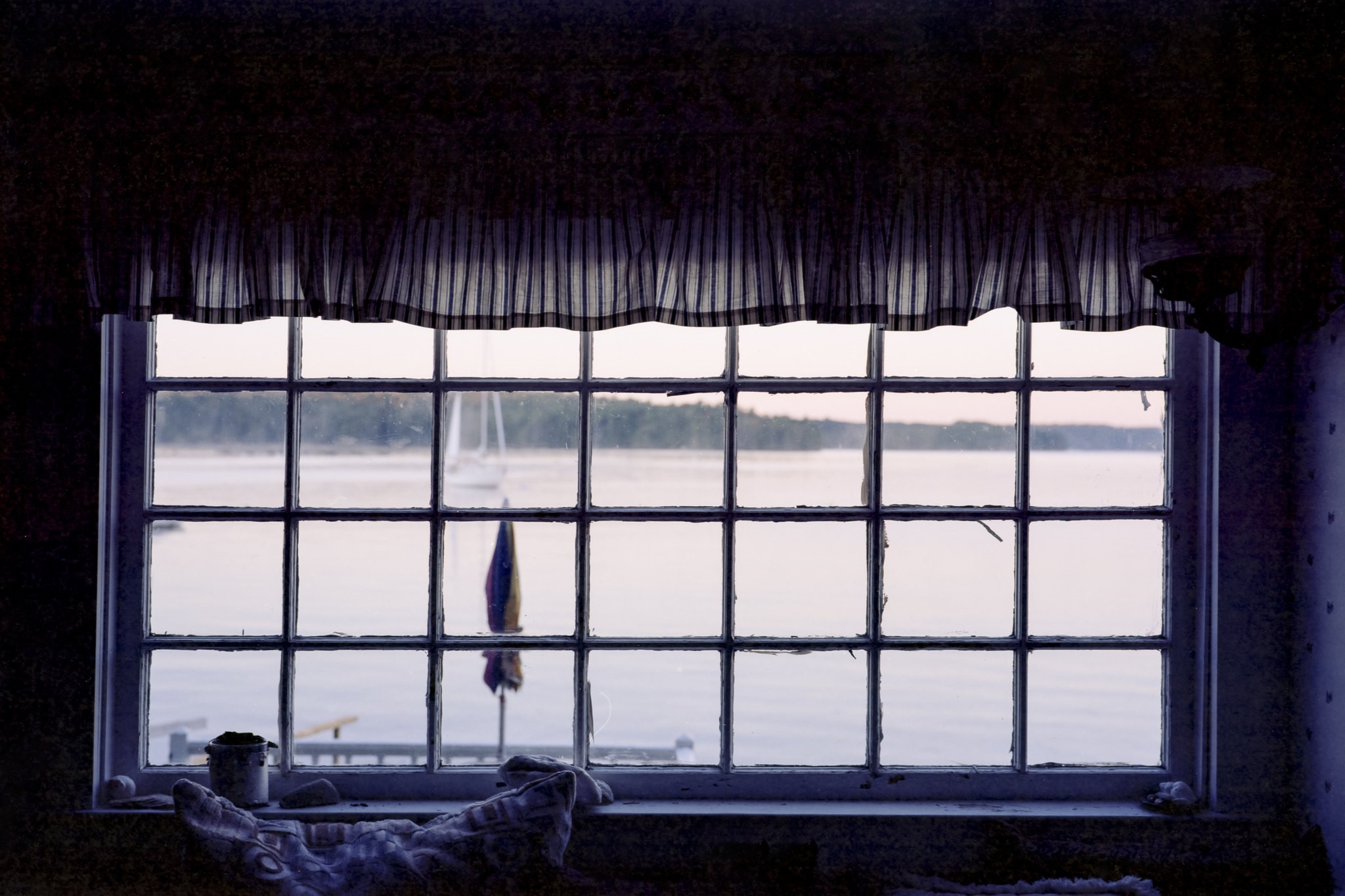 View through a window of a lake and sailboat HD Wallpaper