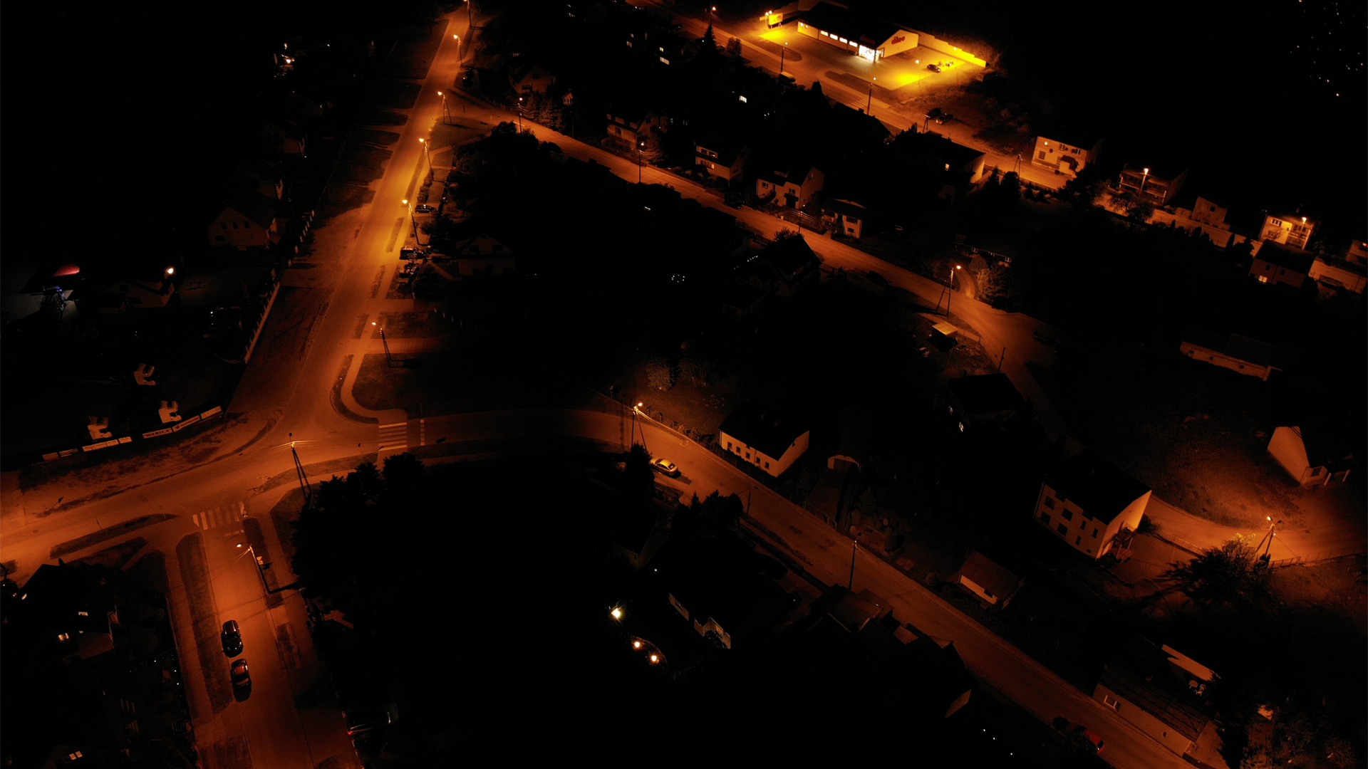 Aerial view of a suburban street at night HD Wallpaper
