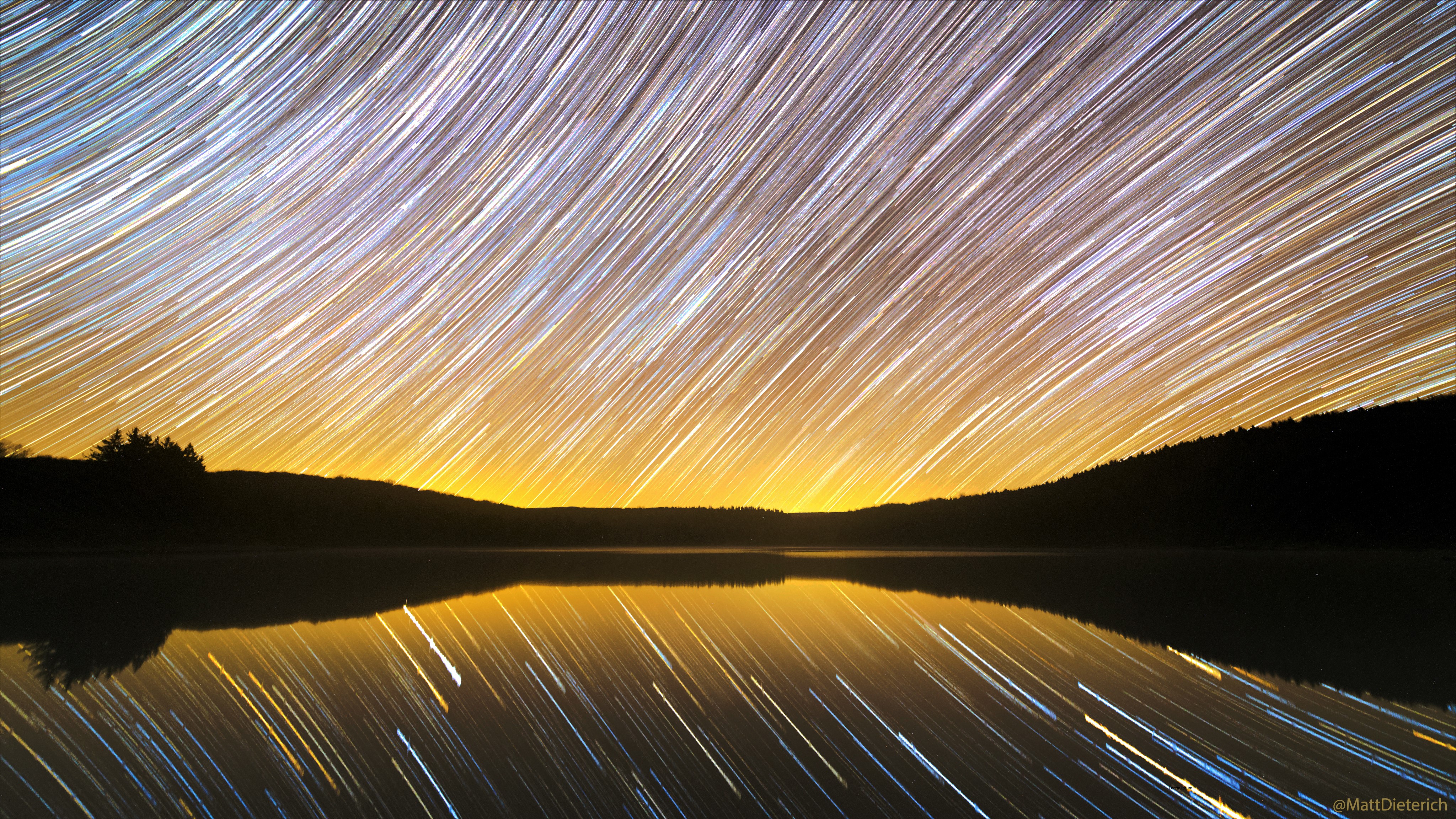 Star trails over a lake at dusk with reflection HD Wallpaper