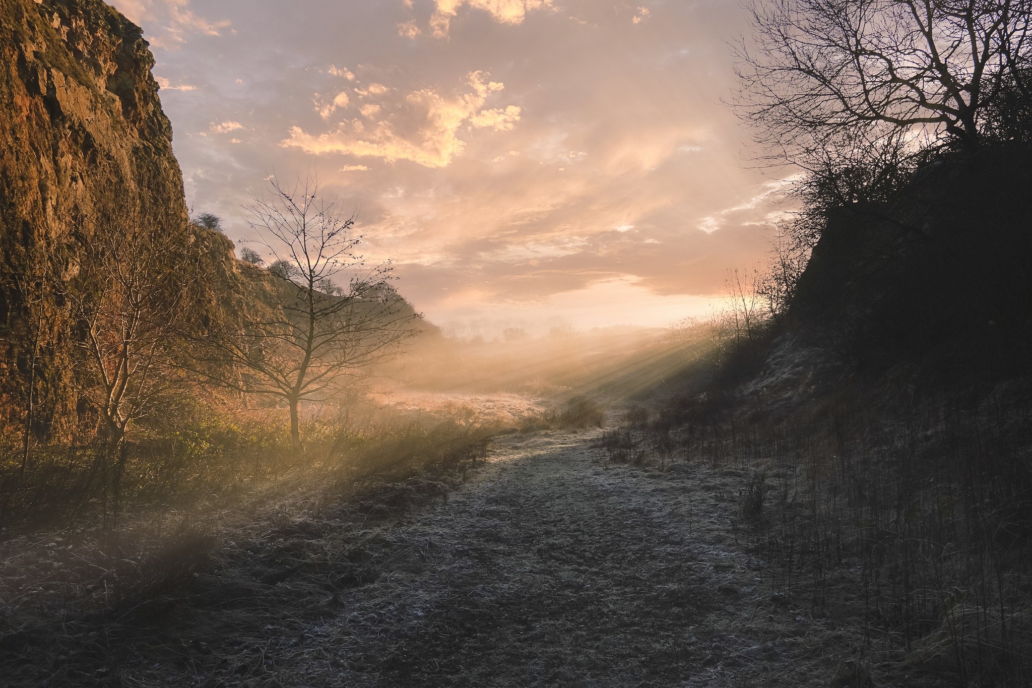 Misty morning sunbeams over a frosty path between rocks HD Wallpaper
