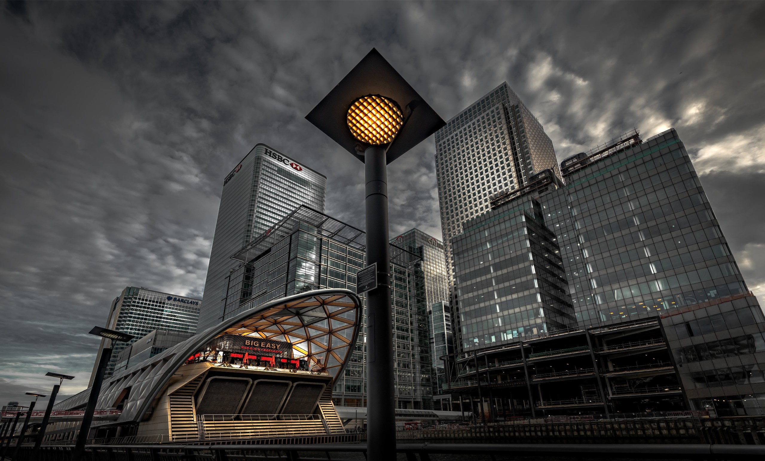 Canary Wharf buildings and station in London under cloudy sky HD Wallpaper