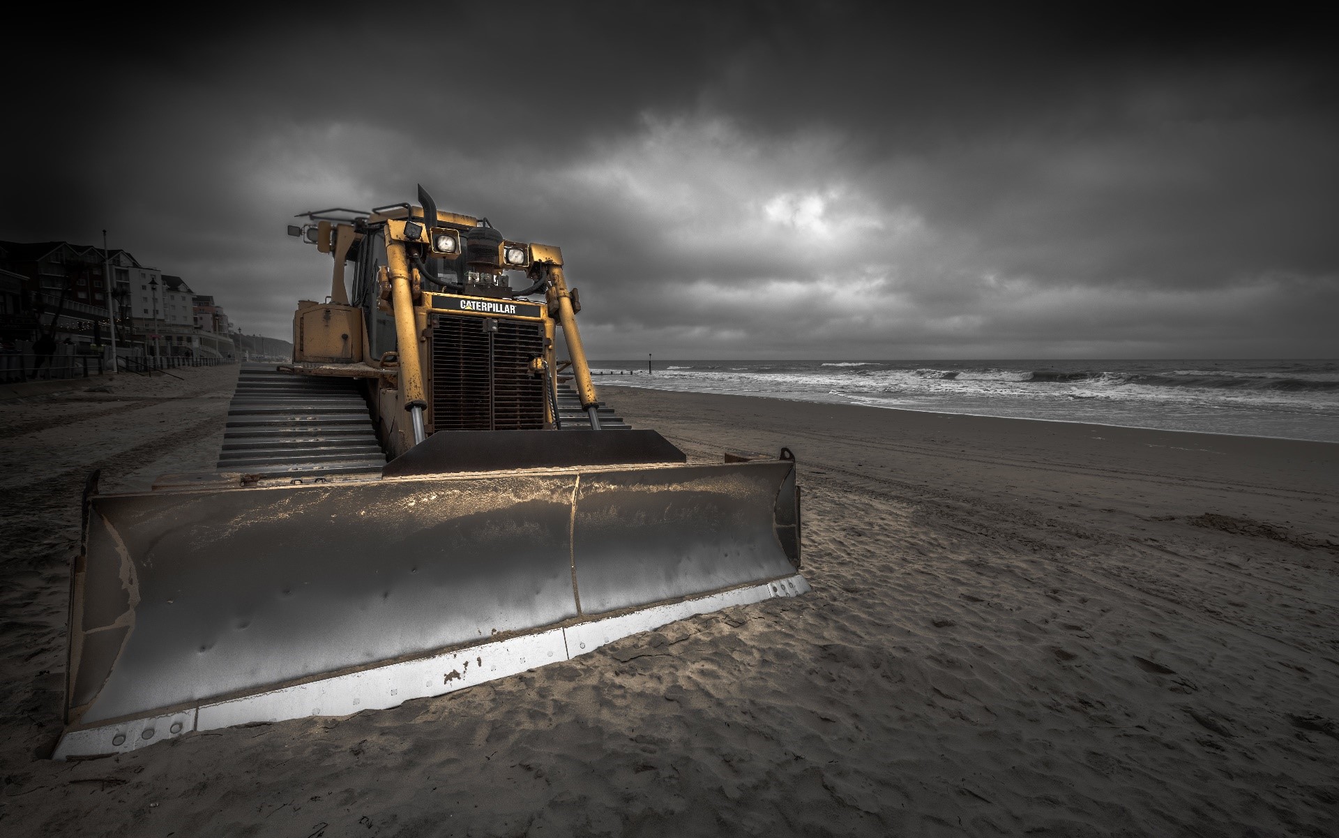 Yellow Caterpillar bulldozer on a sandy beach HD Wallpaper