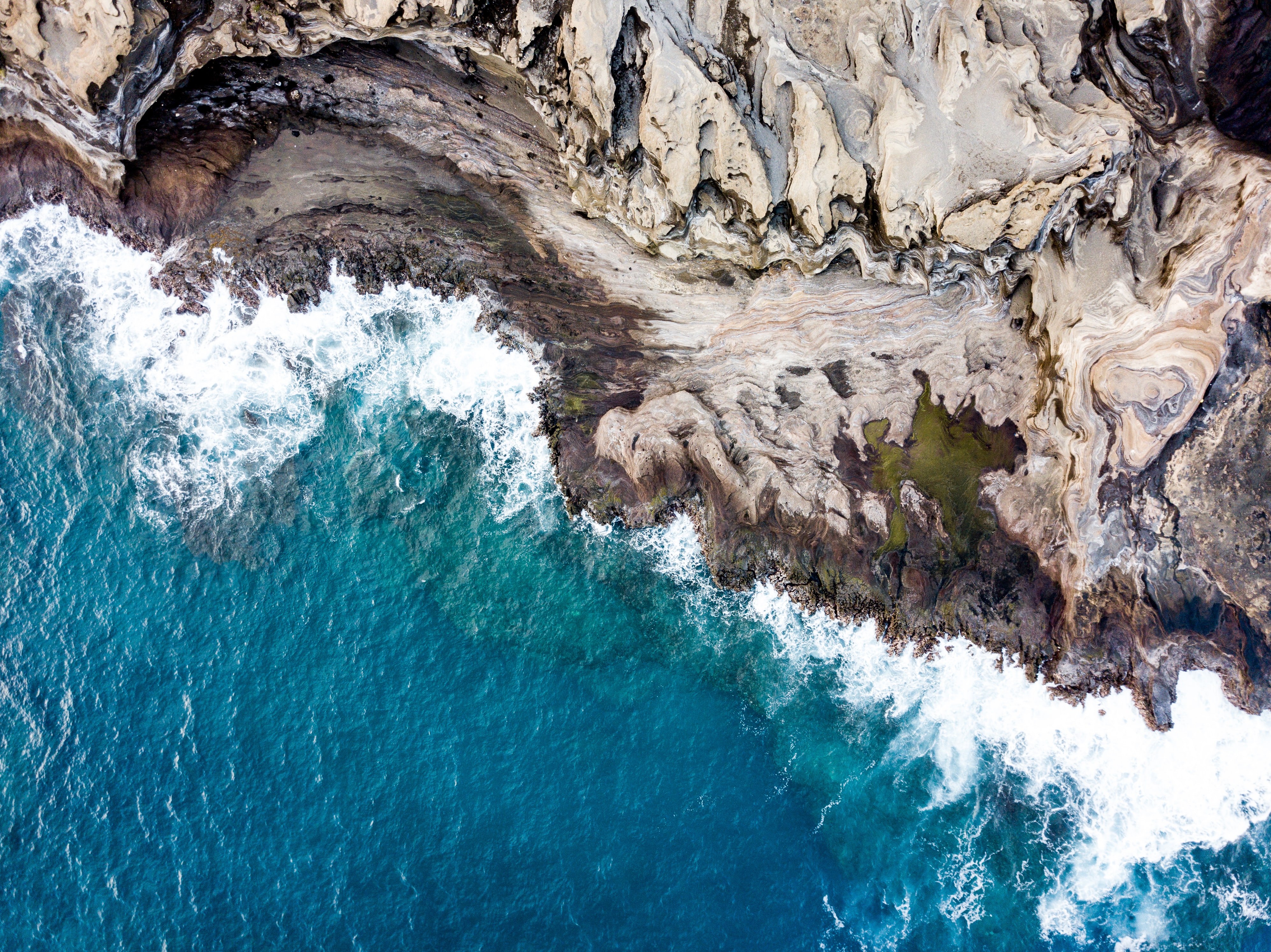 Aerial view of rocky coastline and ocean waves 4K HD Wallpaper