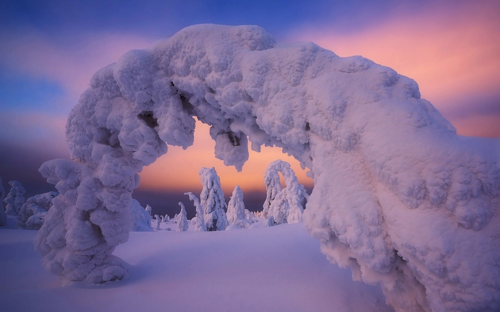 Snow-covered archway in winter landscape at sunset HD Wallpaper