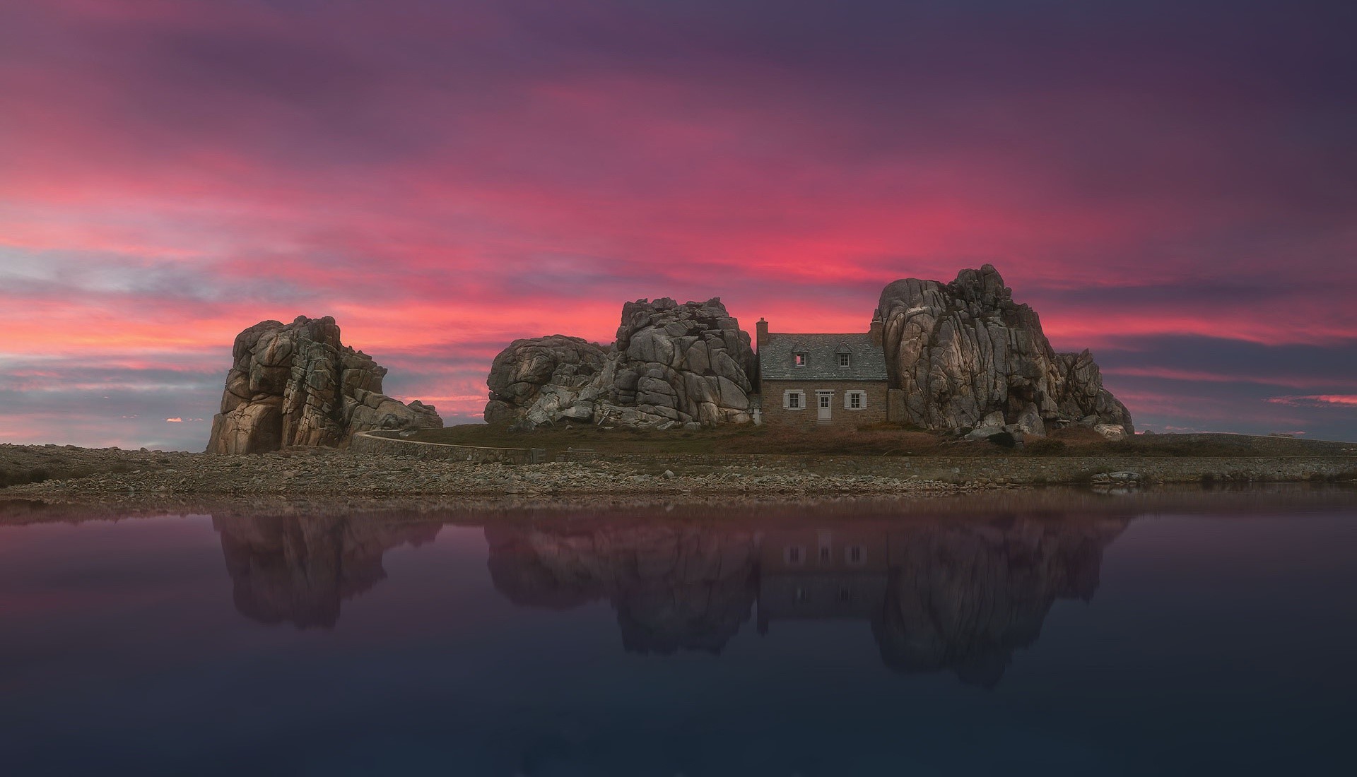 House on rocks with sunset reflection HD Wallpaper