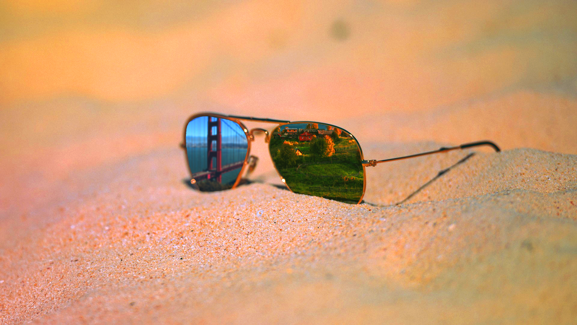 Aviator sunglasses reflecting Golden Gate Bridge and green hills HD Wallpaper