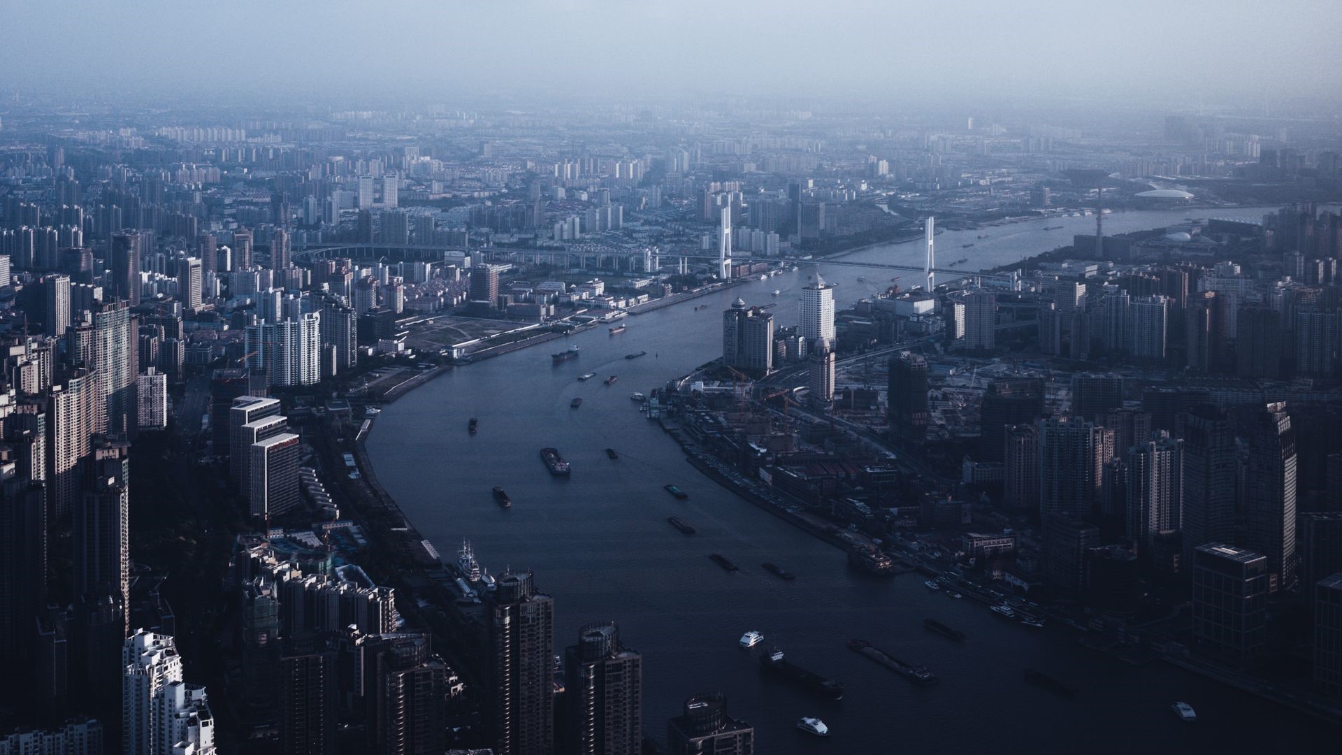 Aerial view of Shanghai cityscape with river and boats HD Wallpaper