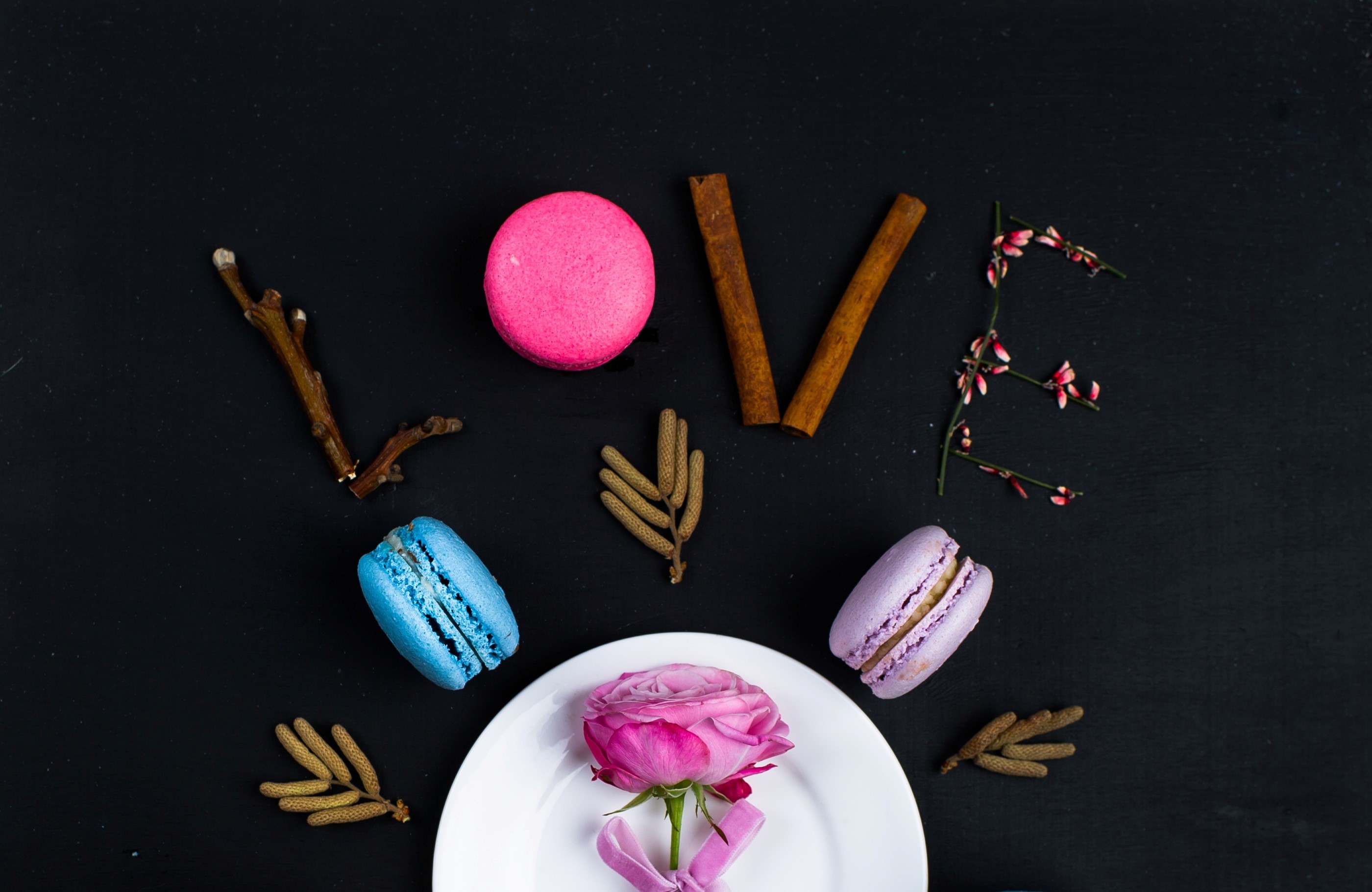 Love spelled with macarons, cinnamon, and flowers HD Wallpaper