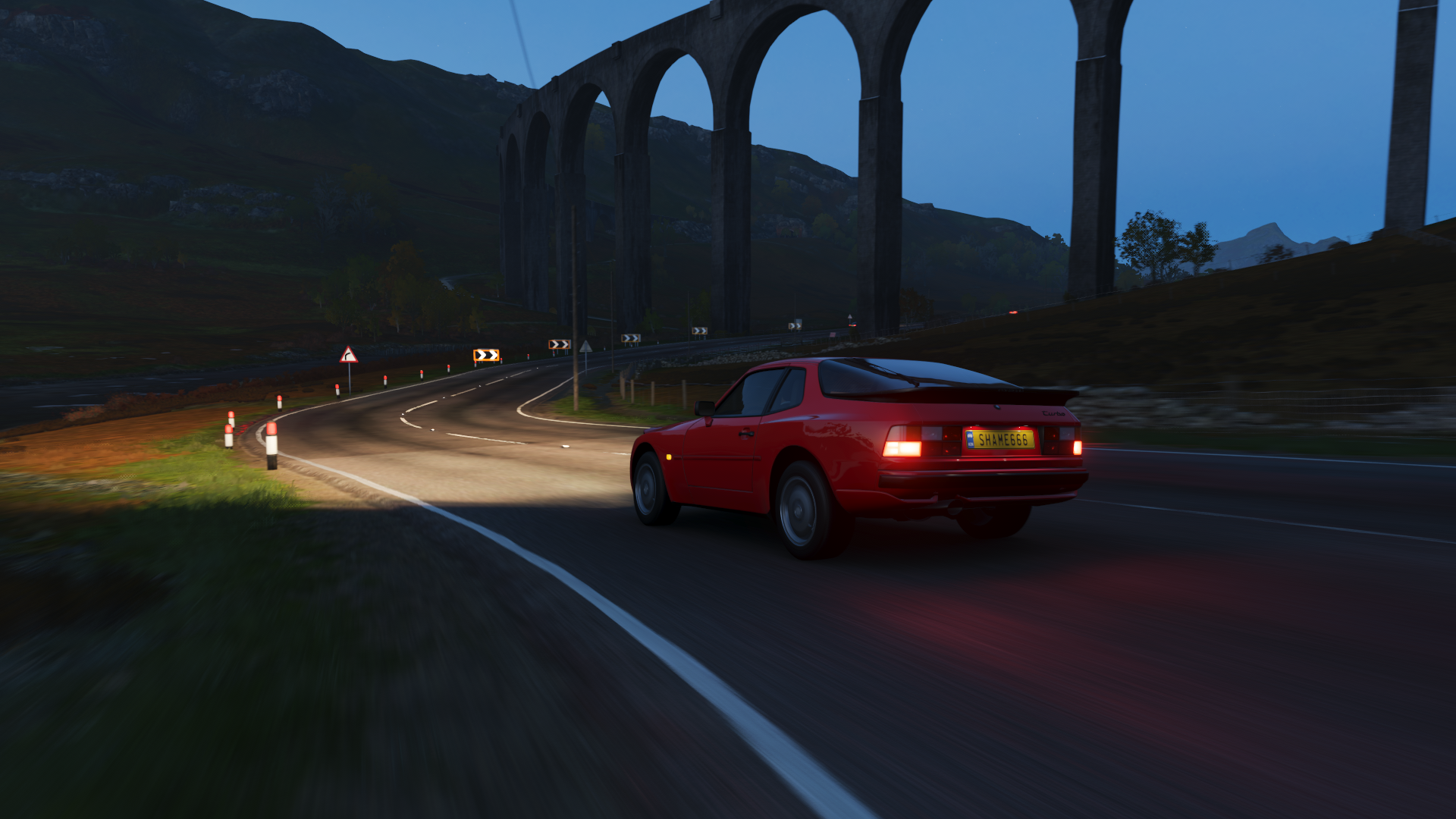 Red Porsche 944 driving on a road in Forza Horizon 4 HD Wallpaper