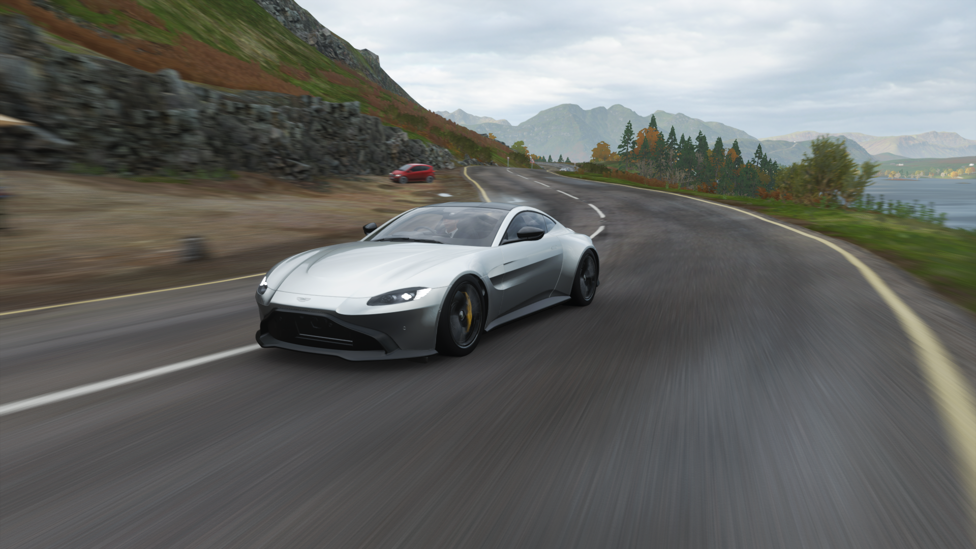 Aston Martin Vantage driving on a road in Forza Horizon 4 HD Wallpaper