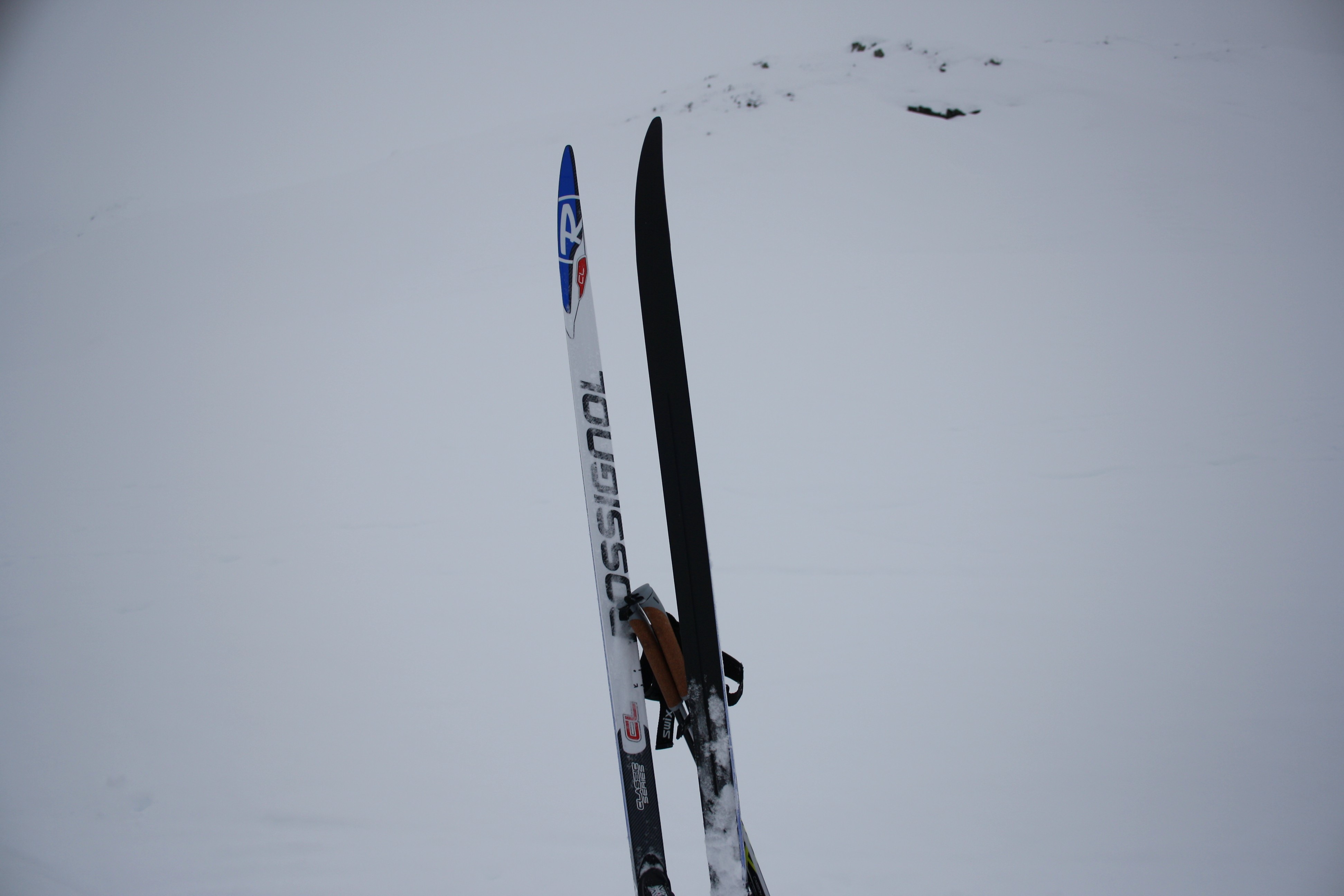 Rossignol skis and poles in snow HD Wallpaper
