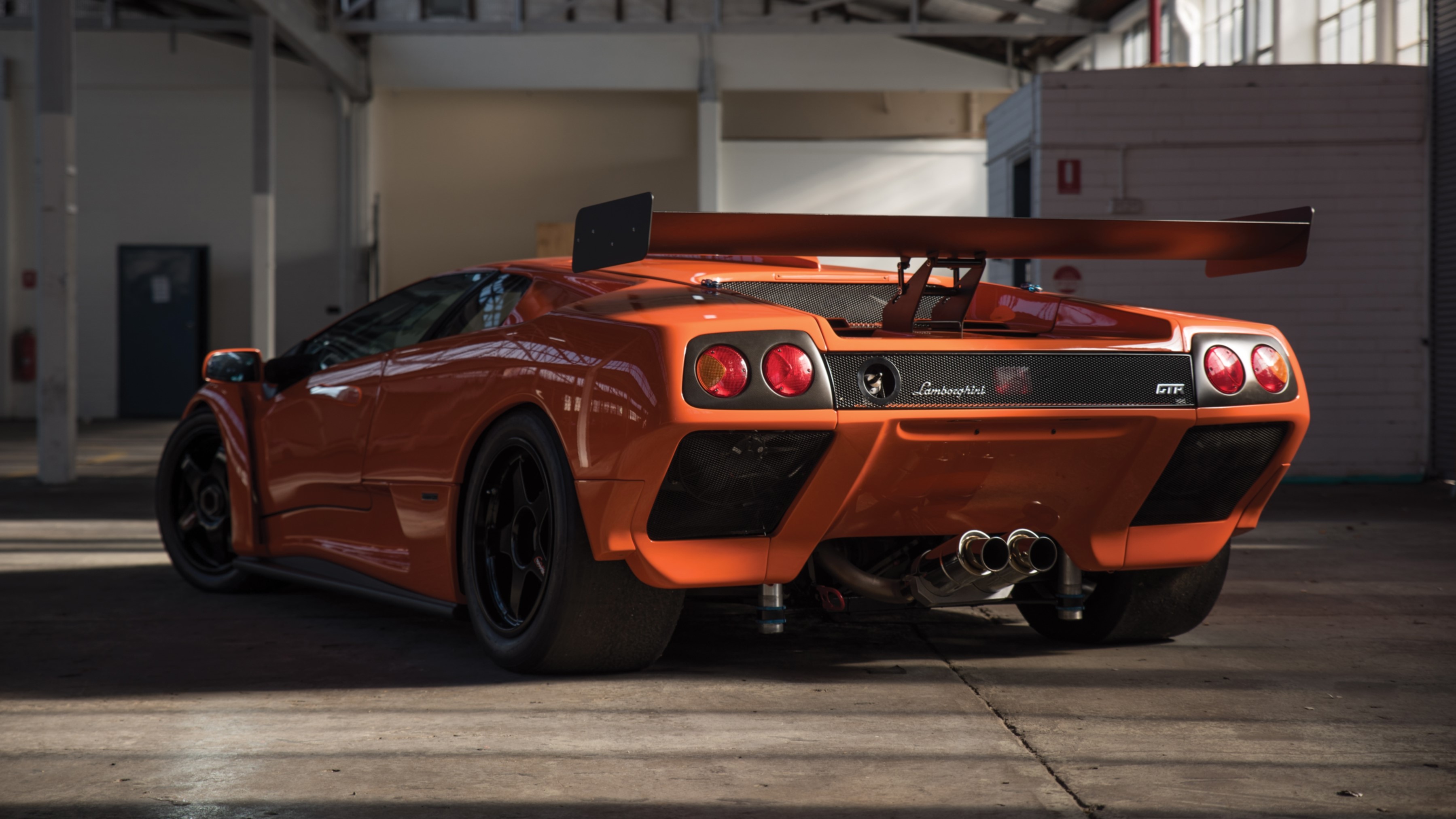 Orange Lamborghini Diablo GTR in a warehouse HD Wallpaper
