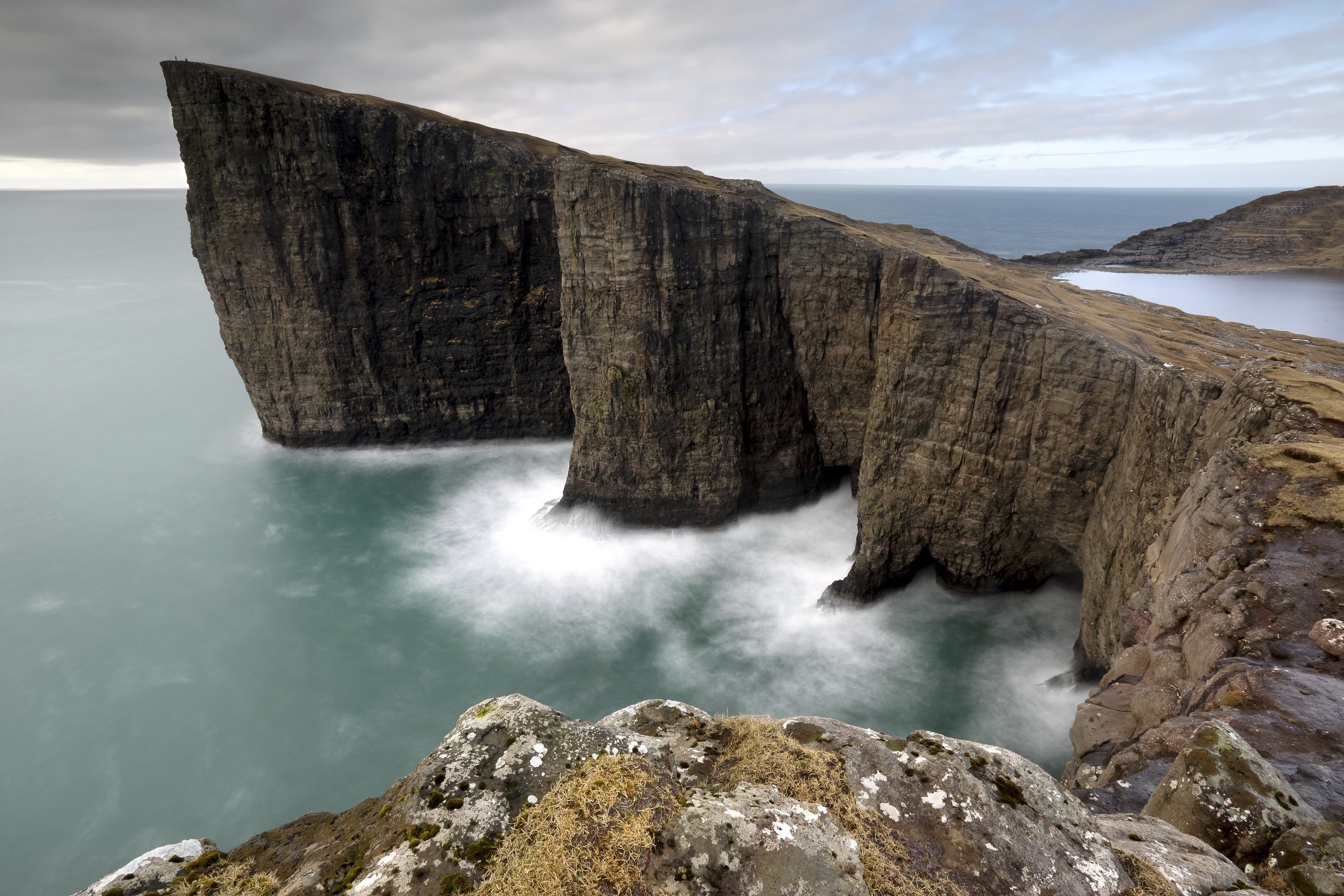 Cliff face in the Faroe Islands with waves crashing HD Wallpaper