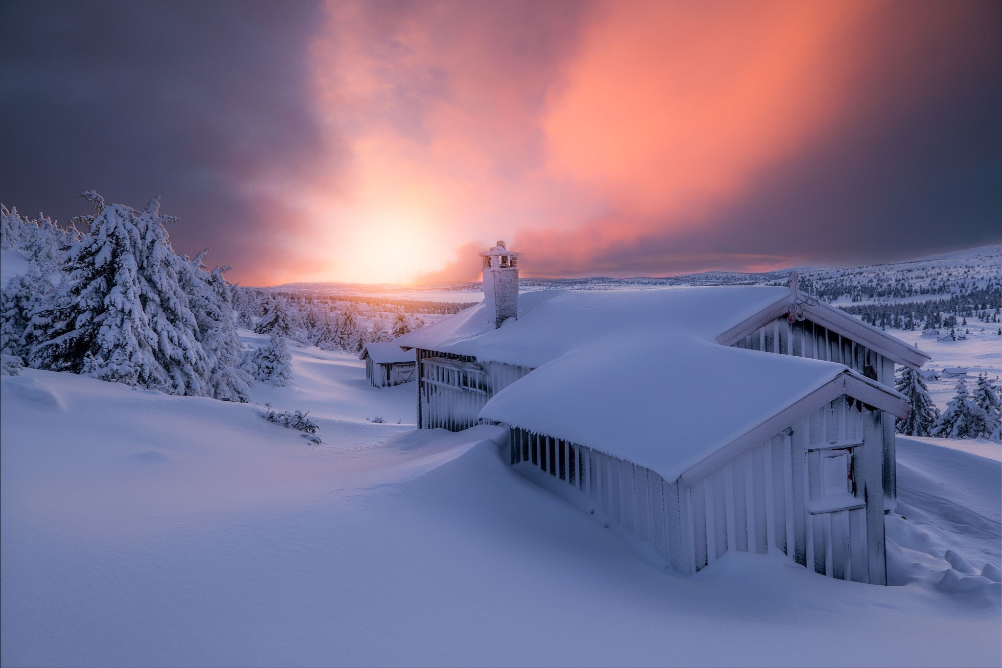 Snowy cabins at sunset with pink sky HD Wallpaper