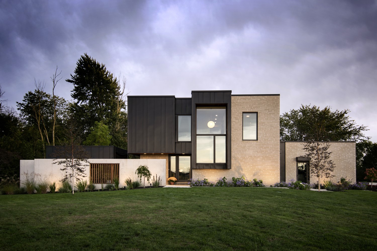 Modern house with large windows and brick exterior HD Wallpaper