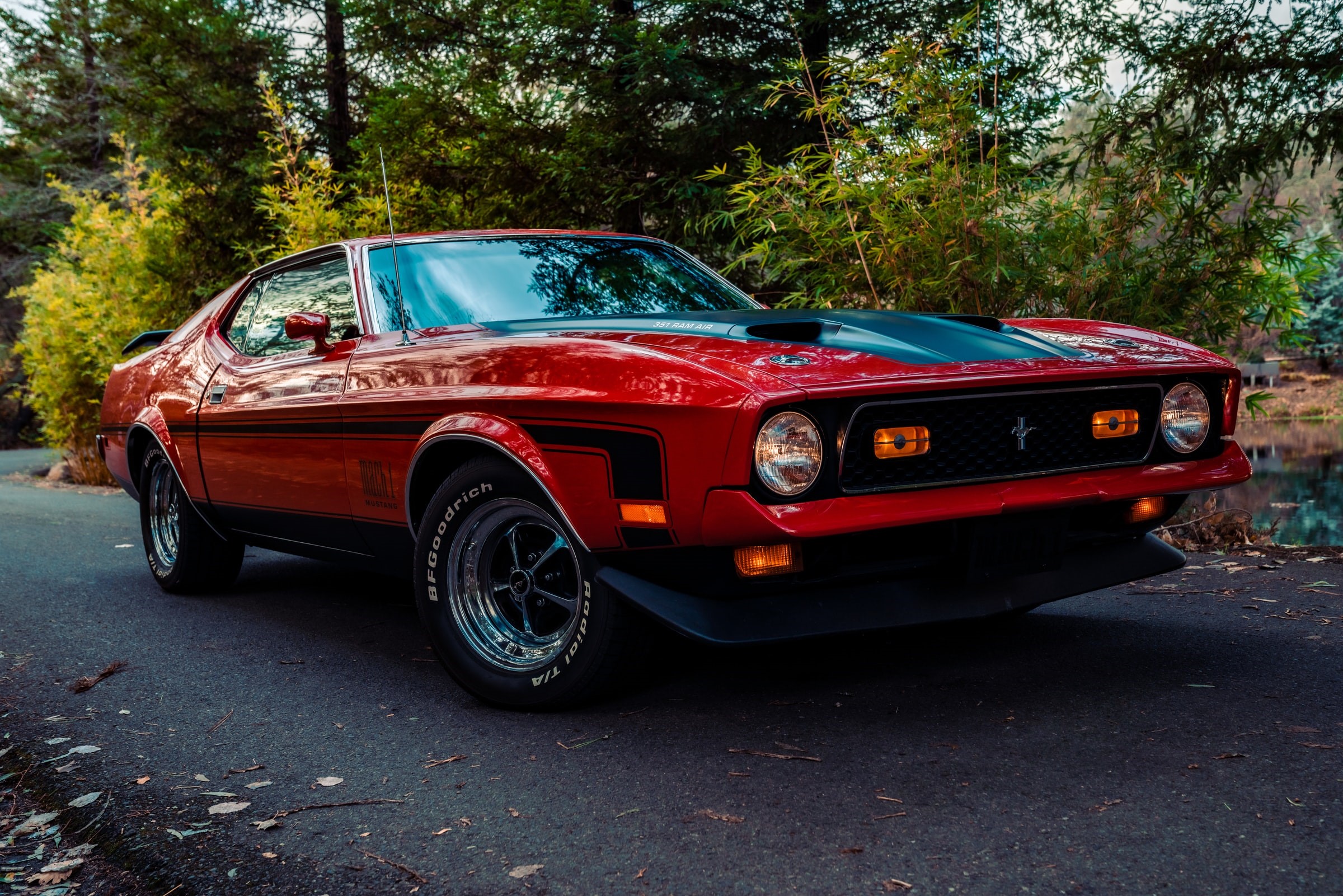Red Ford Mustang Mach 1 parked on asphalt road HD Wallpaper