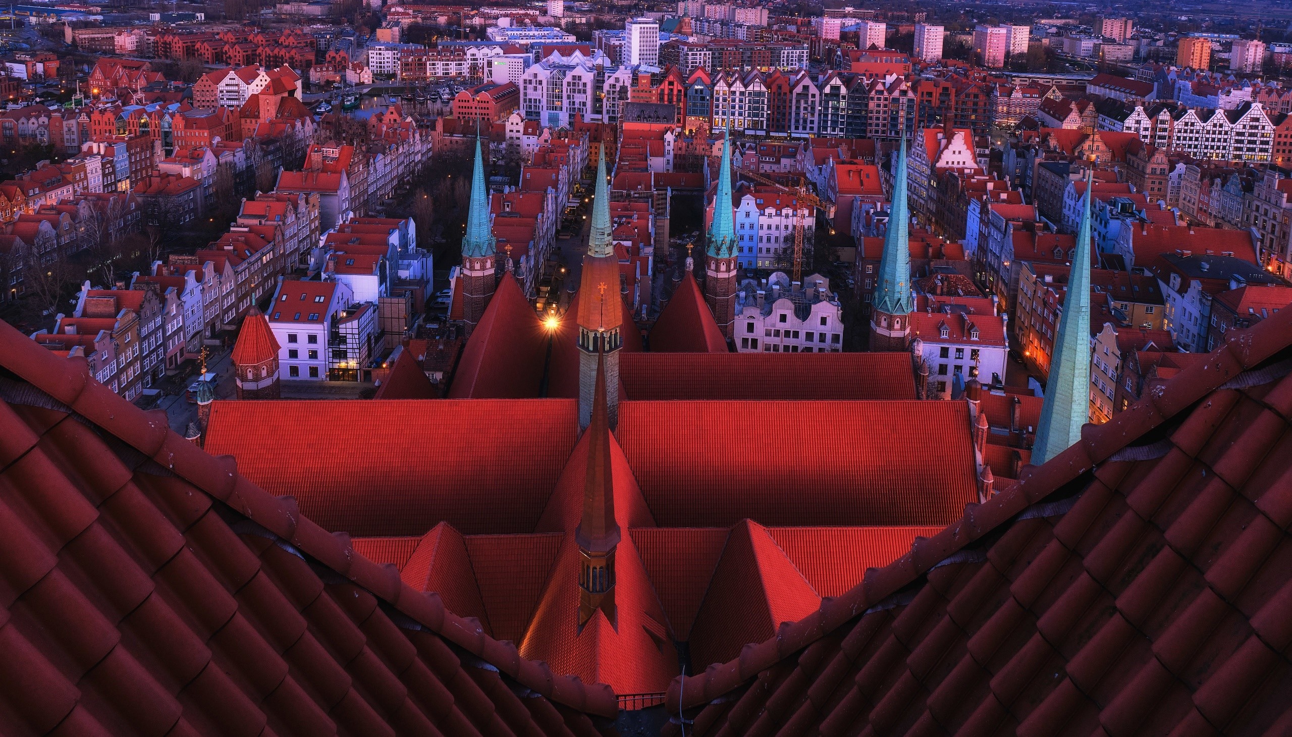 Aerial view of Gdańsk rooftops at dusk HD Wallpaper