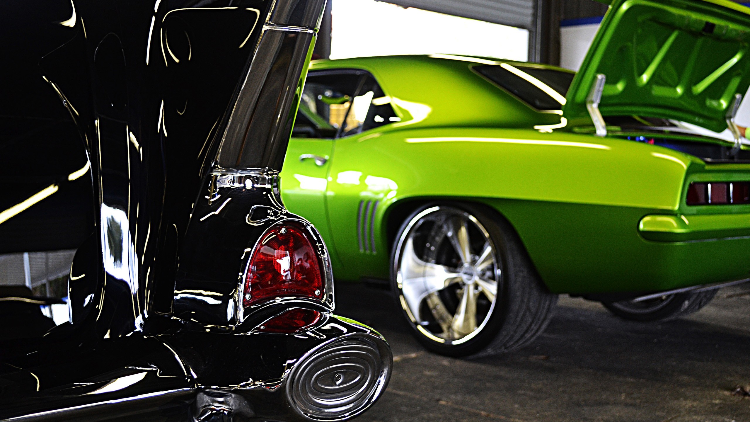 Black and green classic cars in a garage HD Wallpaper