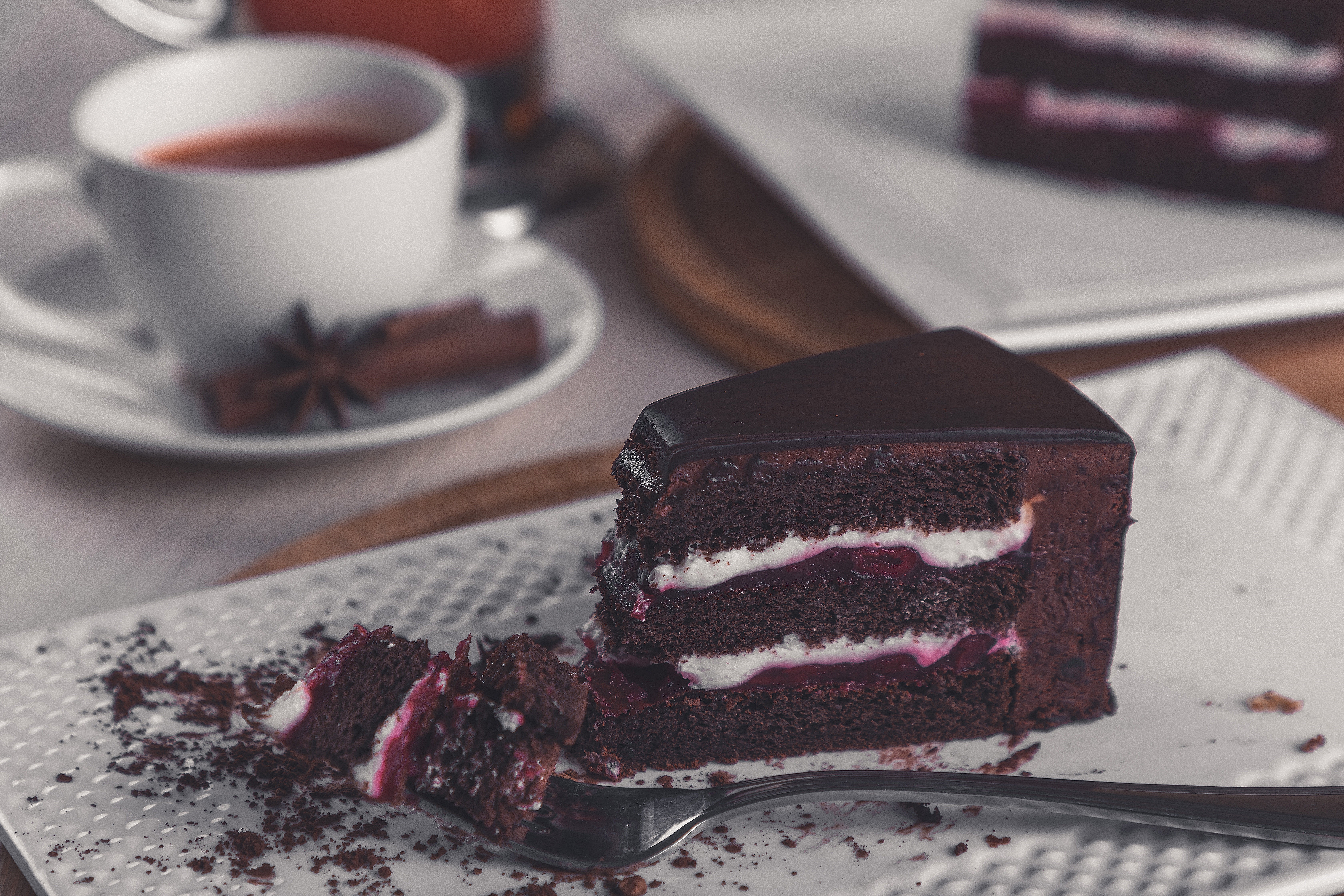Chocolate cake with cream and cherry on a plate with a fork HD Wallpaper