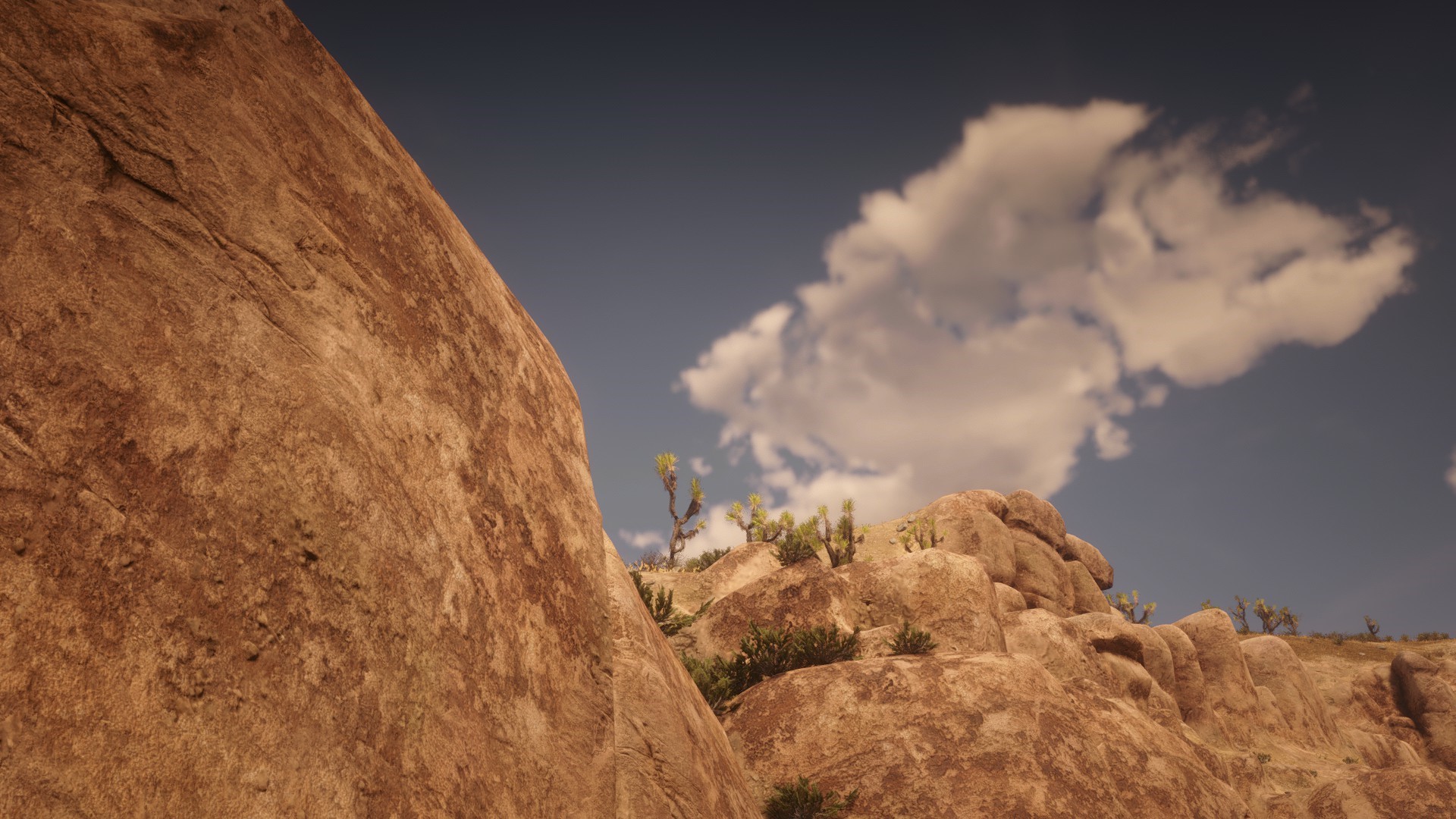 Red Dead Redemption 2 desert landscape with rocks and sky HD Wallpaper