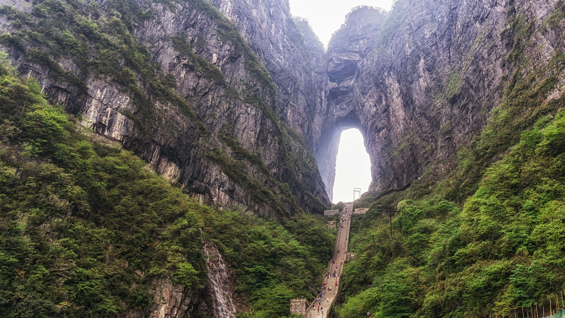Tianmen Mountain natural arch with stairs and trees HD Wallpaper