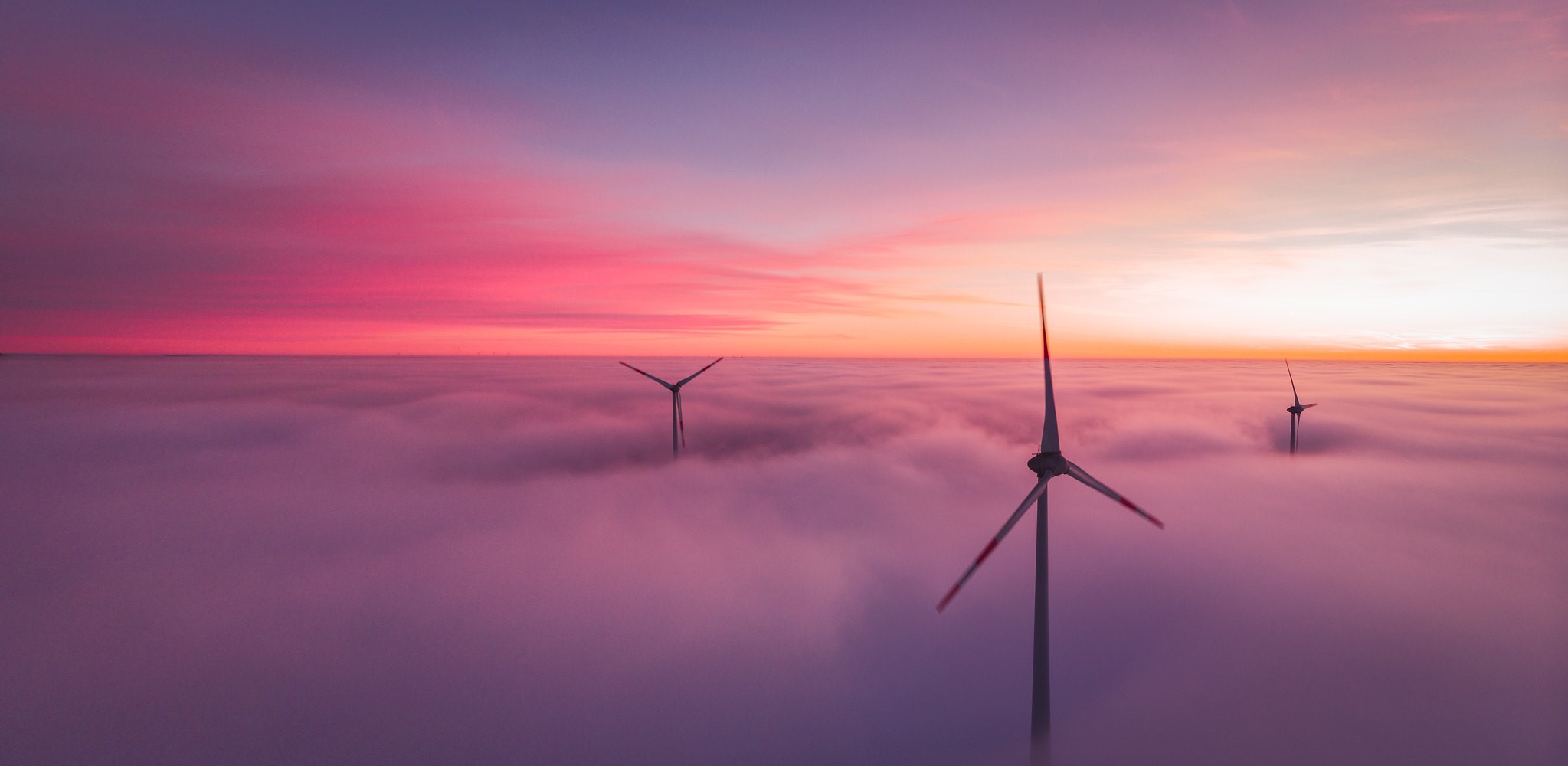 Wind turbines in clouds at sunset HD Wallpaper