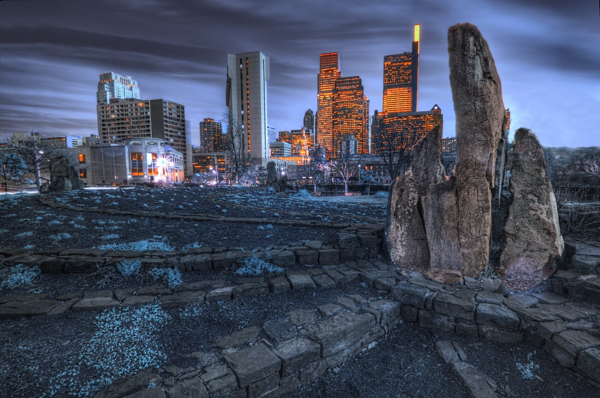 Cityscape with large rocks in the foreground HD Wallpaper