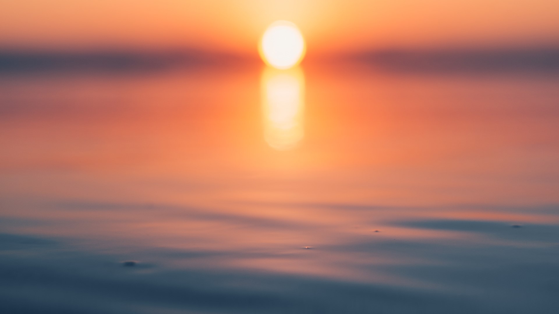 Sunset over calm water with reflection HD Wallpaper