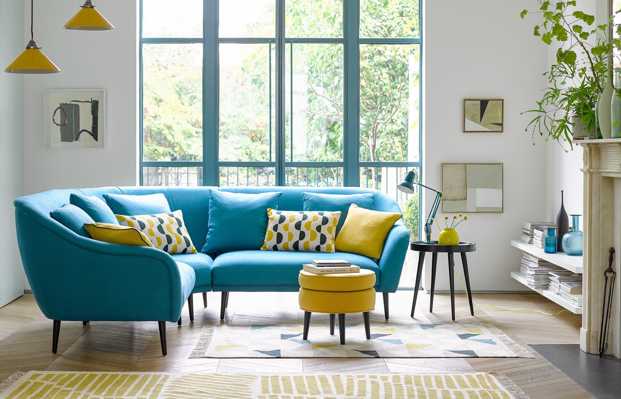 Living room with blue sofa and yellow accents HD Wallpaper