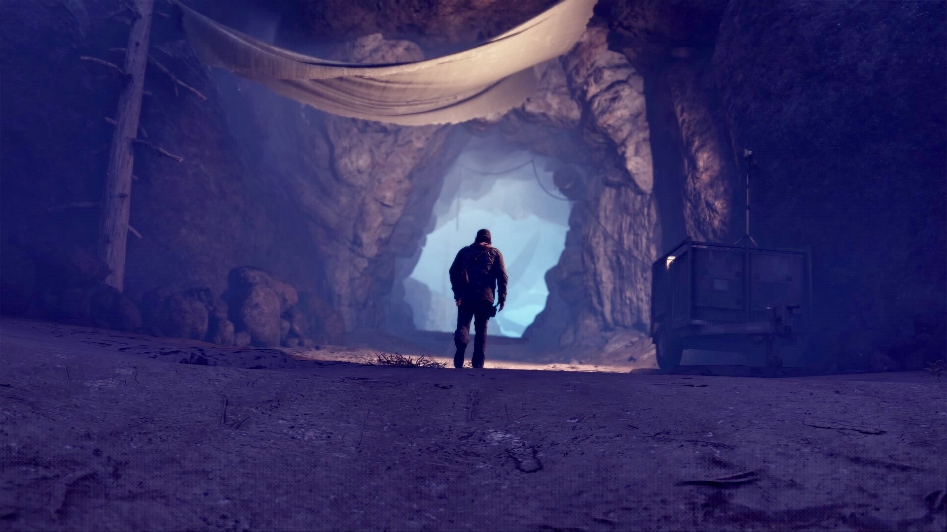 Man walking into a cave entrance in Days Gone HD Wallpaper