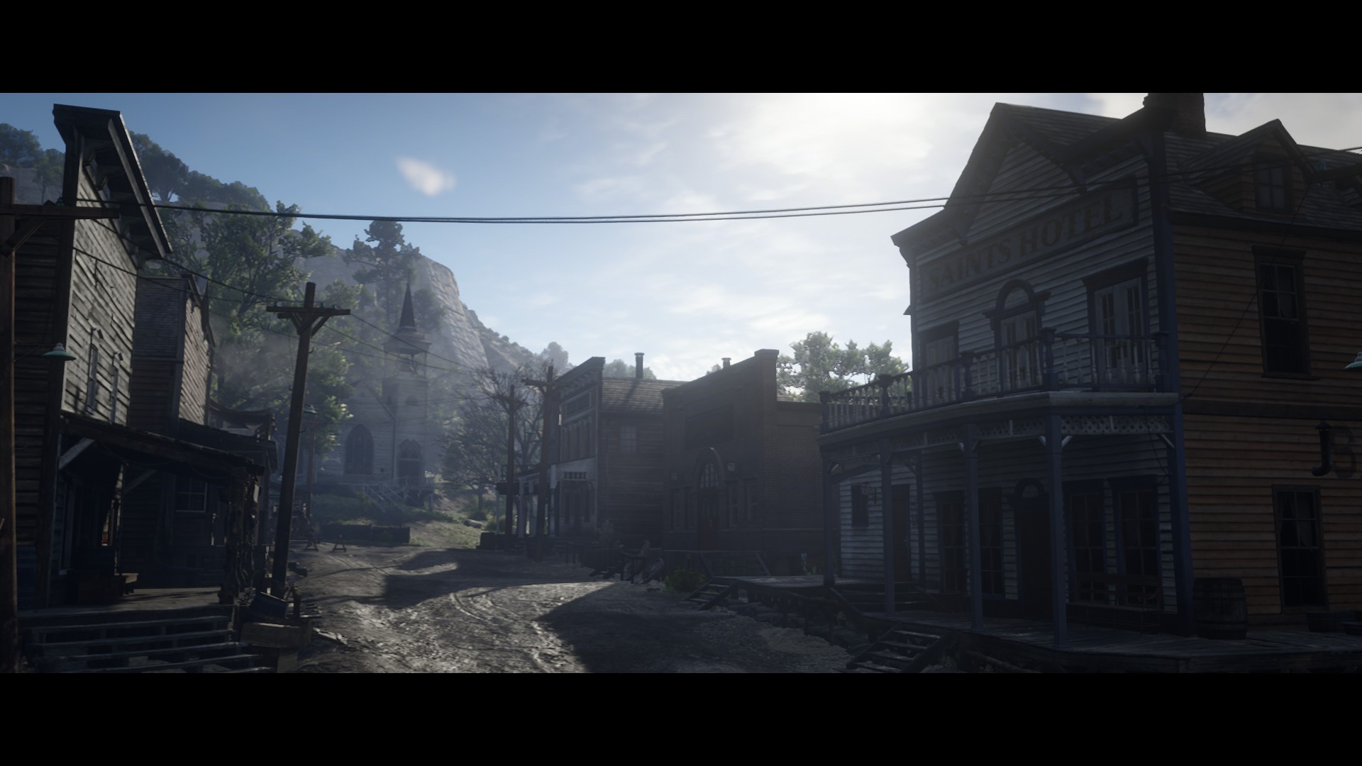Red Dead Redemption 2 town street with mountains HD Wallpaper