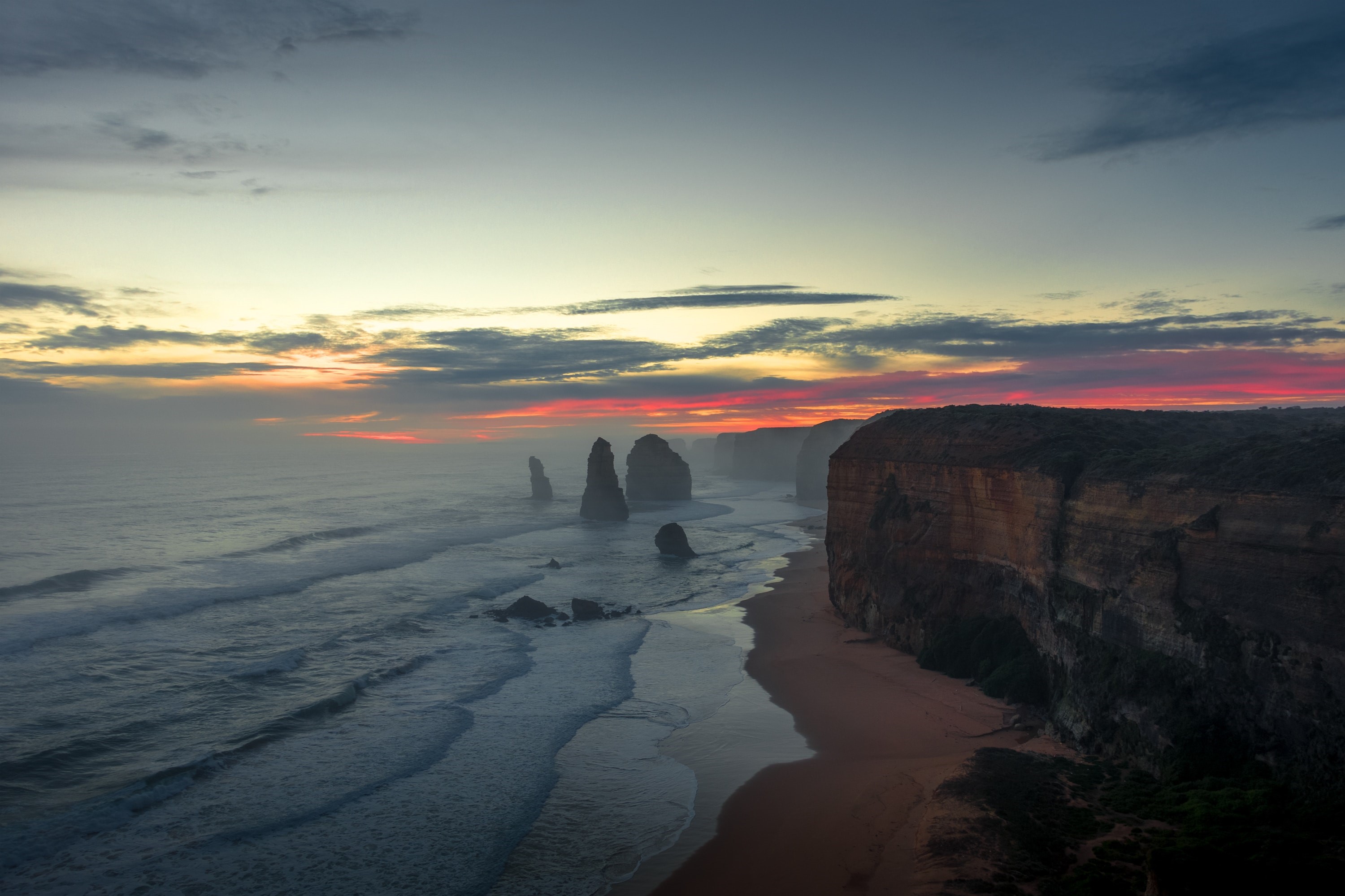 The Twelve Apostles at sunset with mist HD Wallpaper