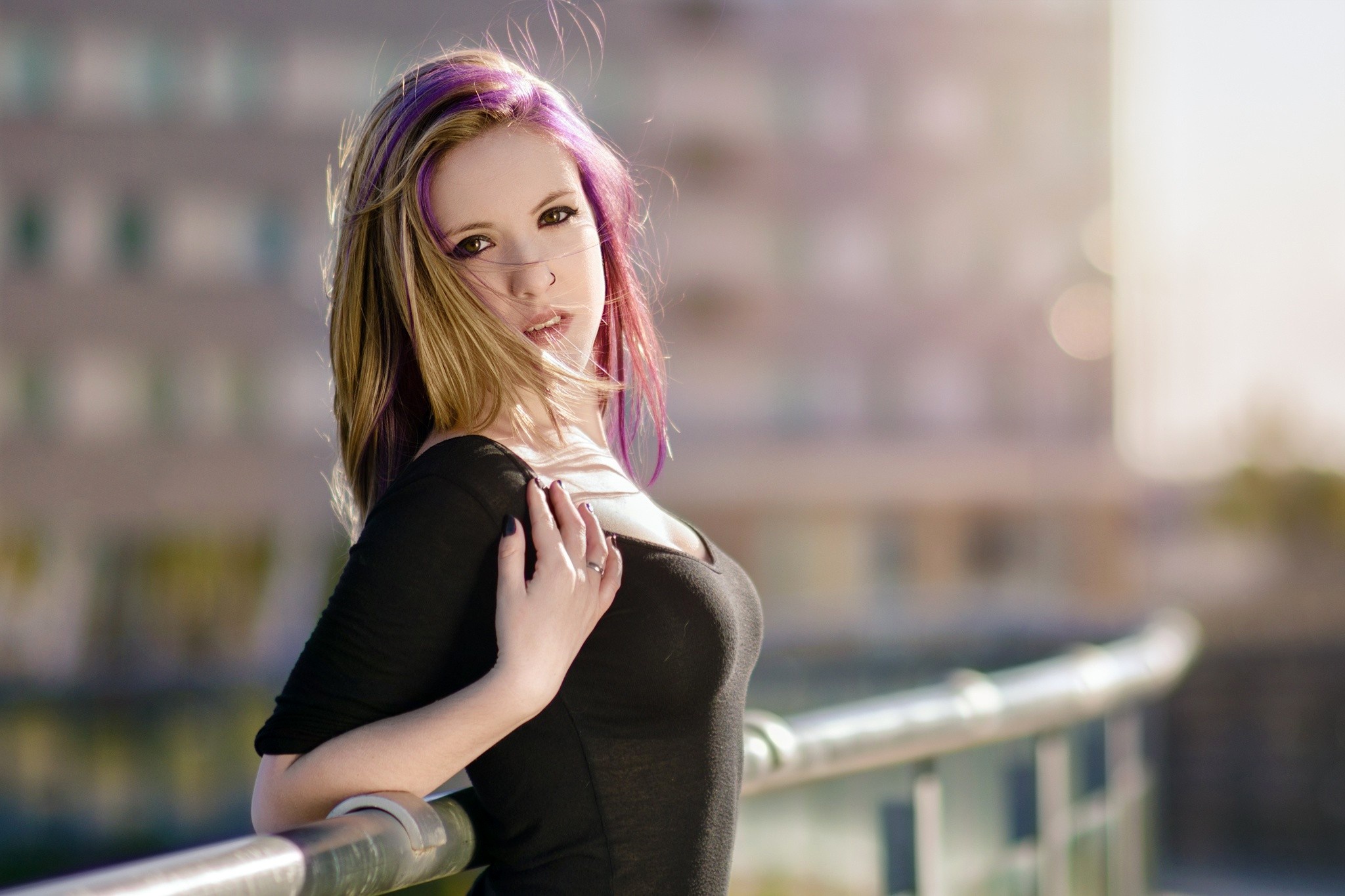 Woman with purple streaks in hair leaning on railing HD Wallpaper