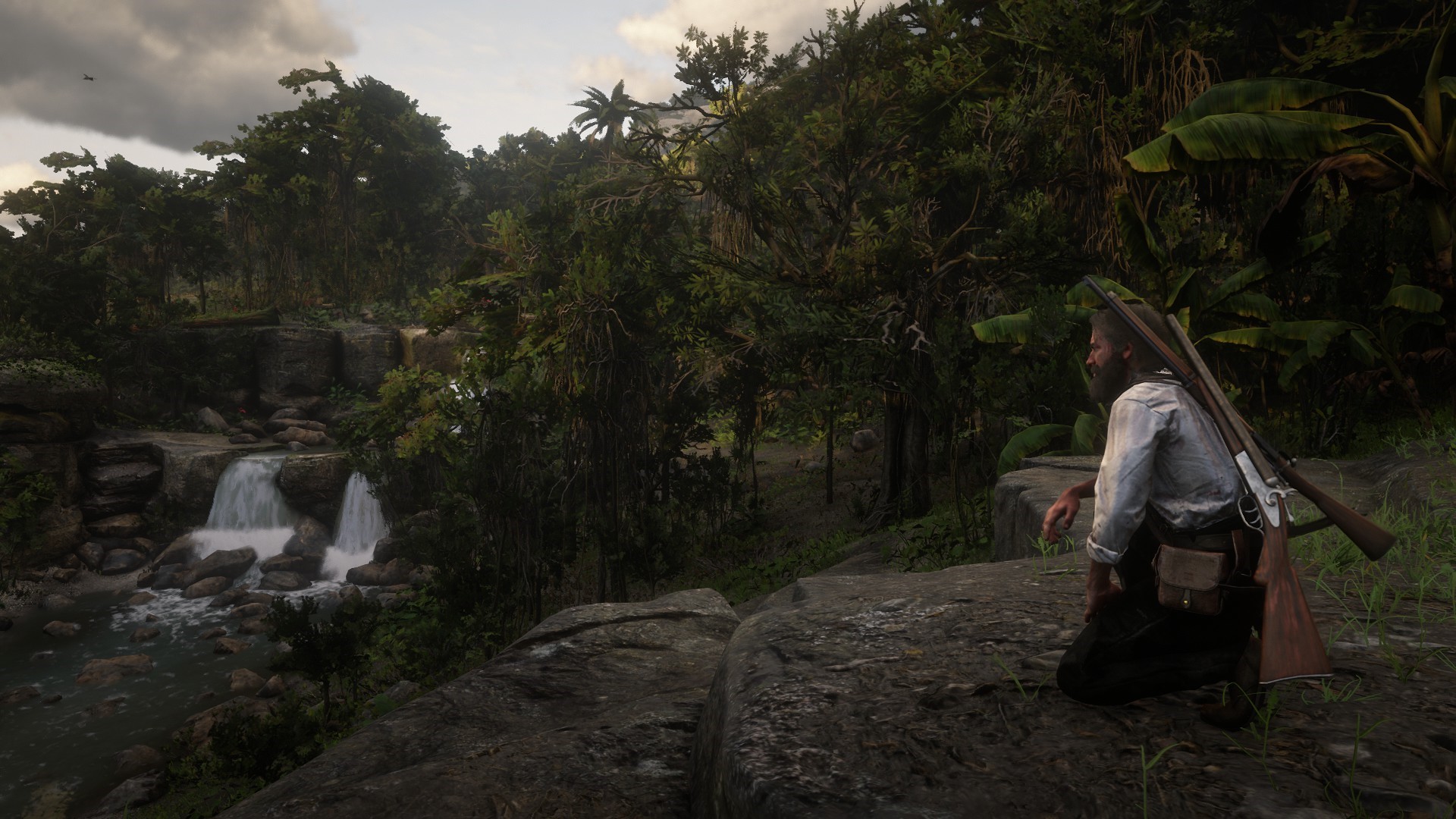 Man with rifle in jungle near waterfall in Red Dead Redemption 2 HD Wallpaper