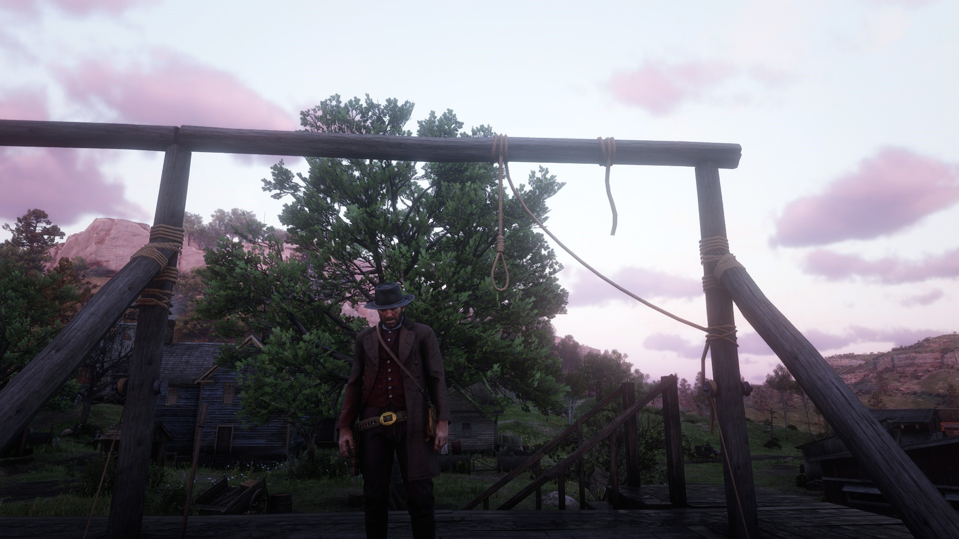 Man in Western attire stands near a gallows in Red Dead Redemption 2 HD Wallpaper