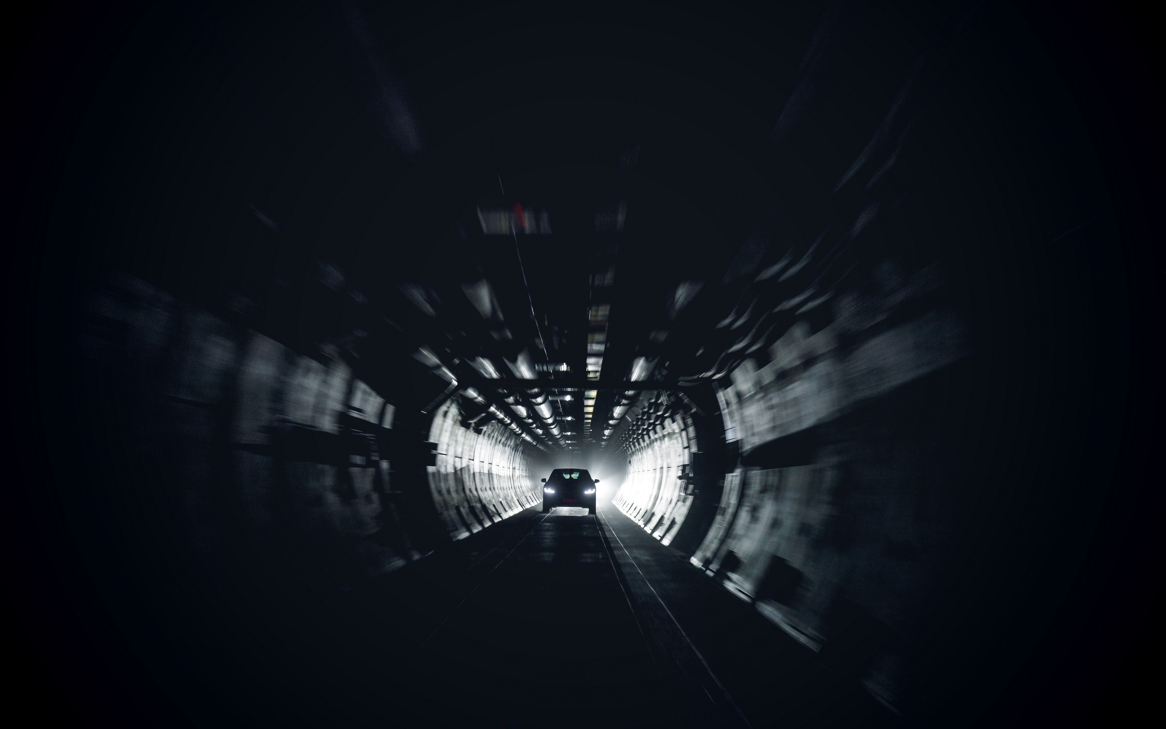 Car driving through a dark tunnel HD Wallpaper