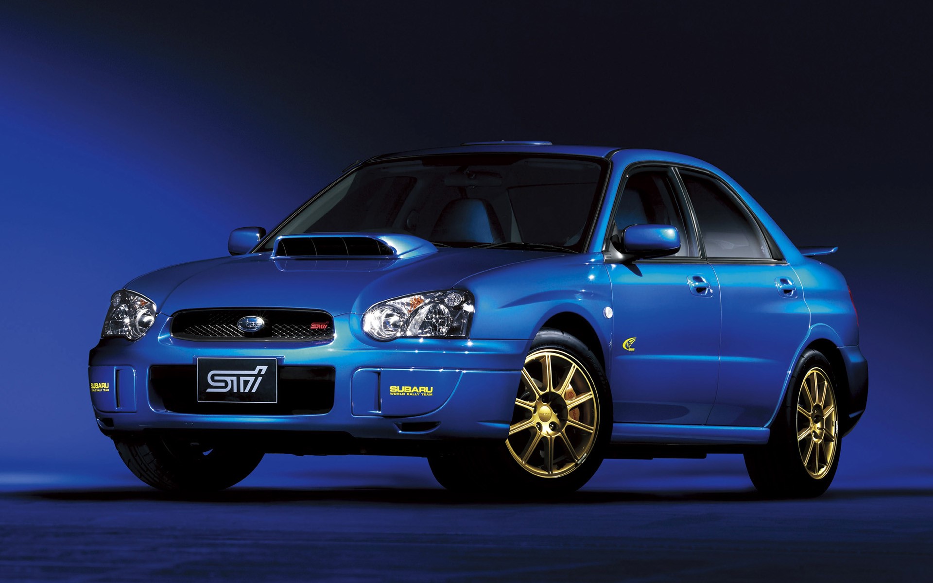 Blue Subaru Impreza WRX STi with gold wheels HD Wallpaper