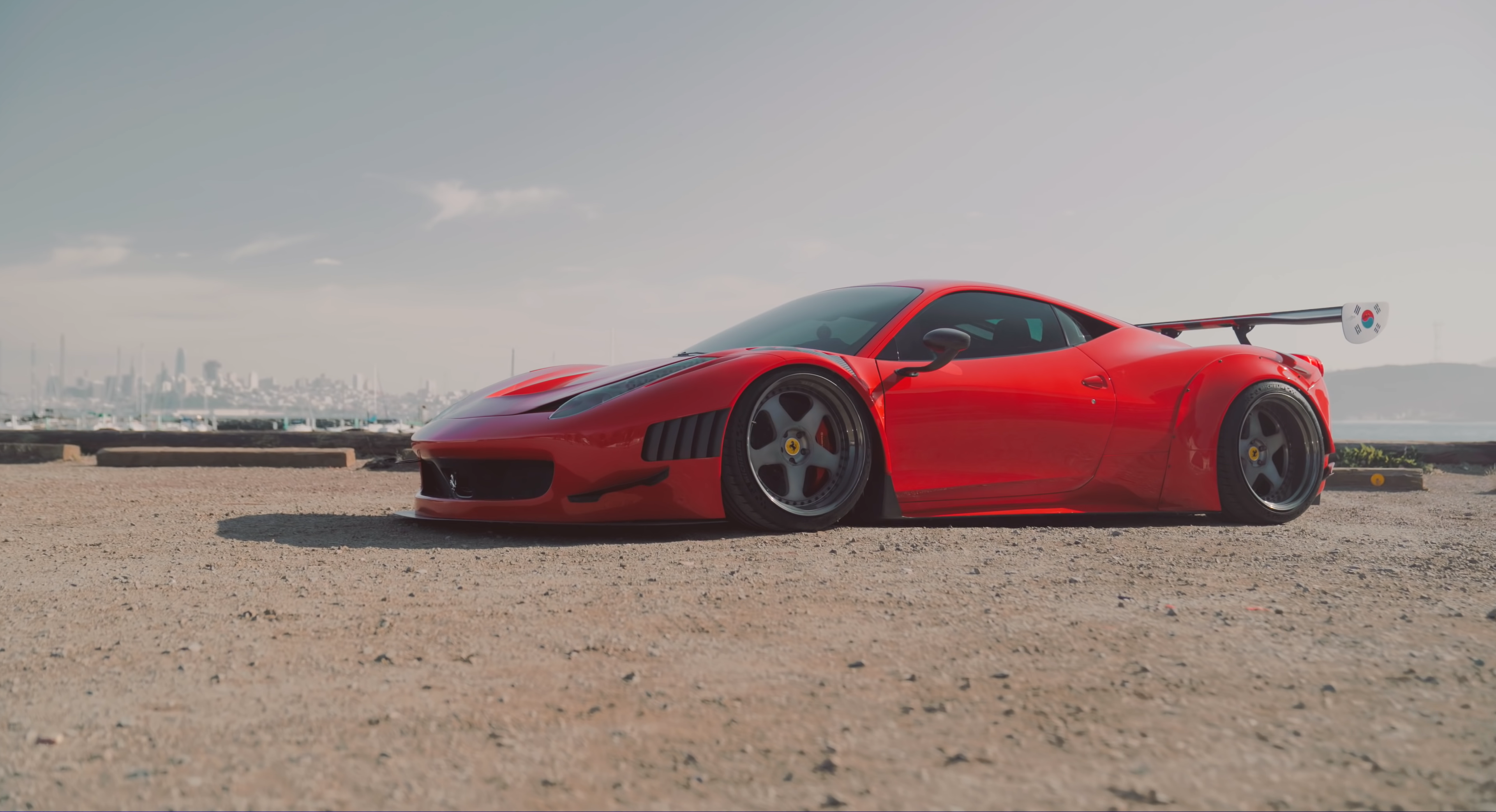 Red Ferrari 458 with spoiler and city skyline HD Wallpaper