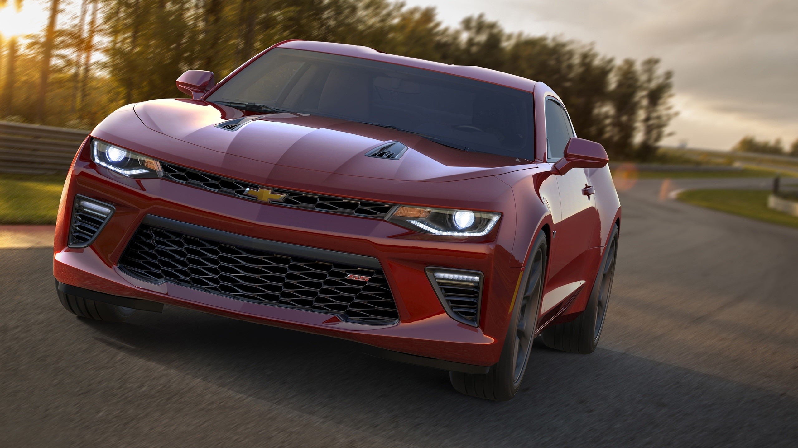 Red Chevrolet Camaro driving on a race track HD Wallpaper