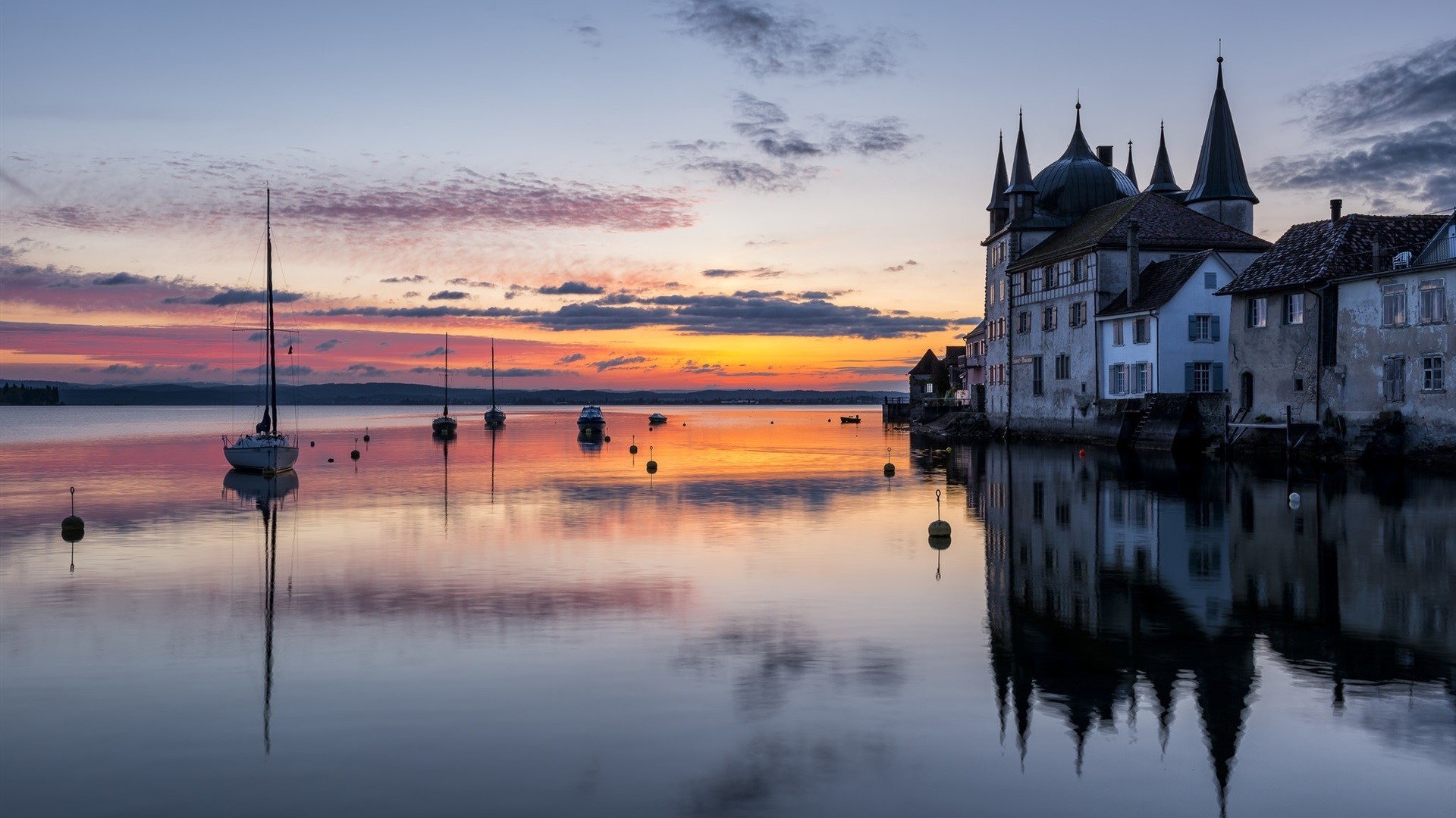 Castle on the water at sunset with sailboats HD Wallpaper