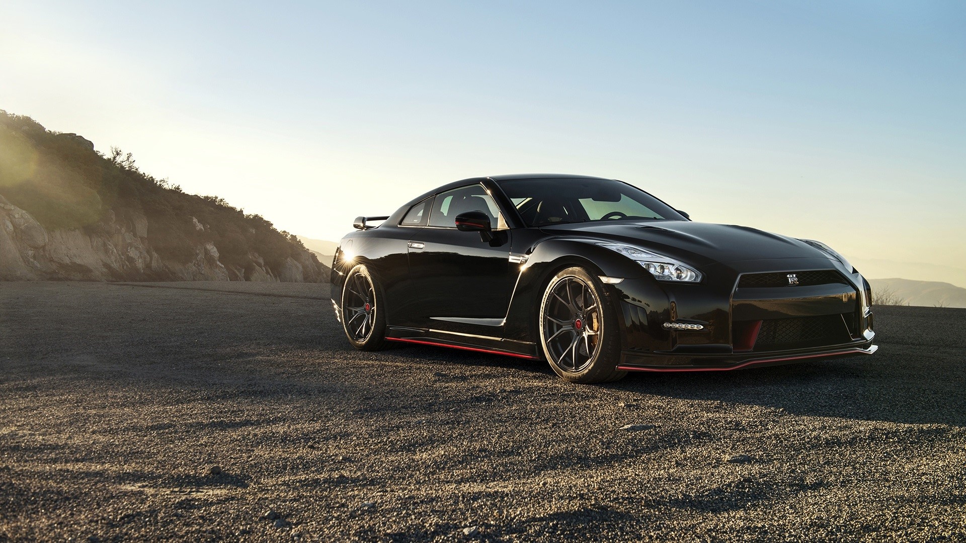 Black Nissan GT-R on a rocky landscape HD Wallpaper