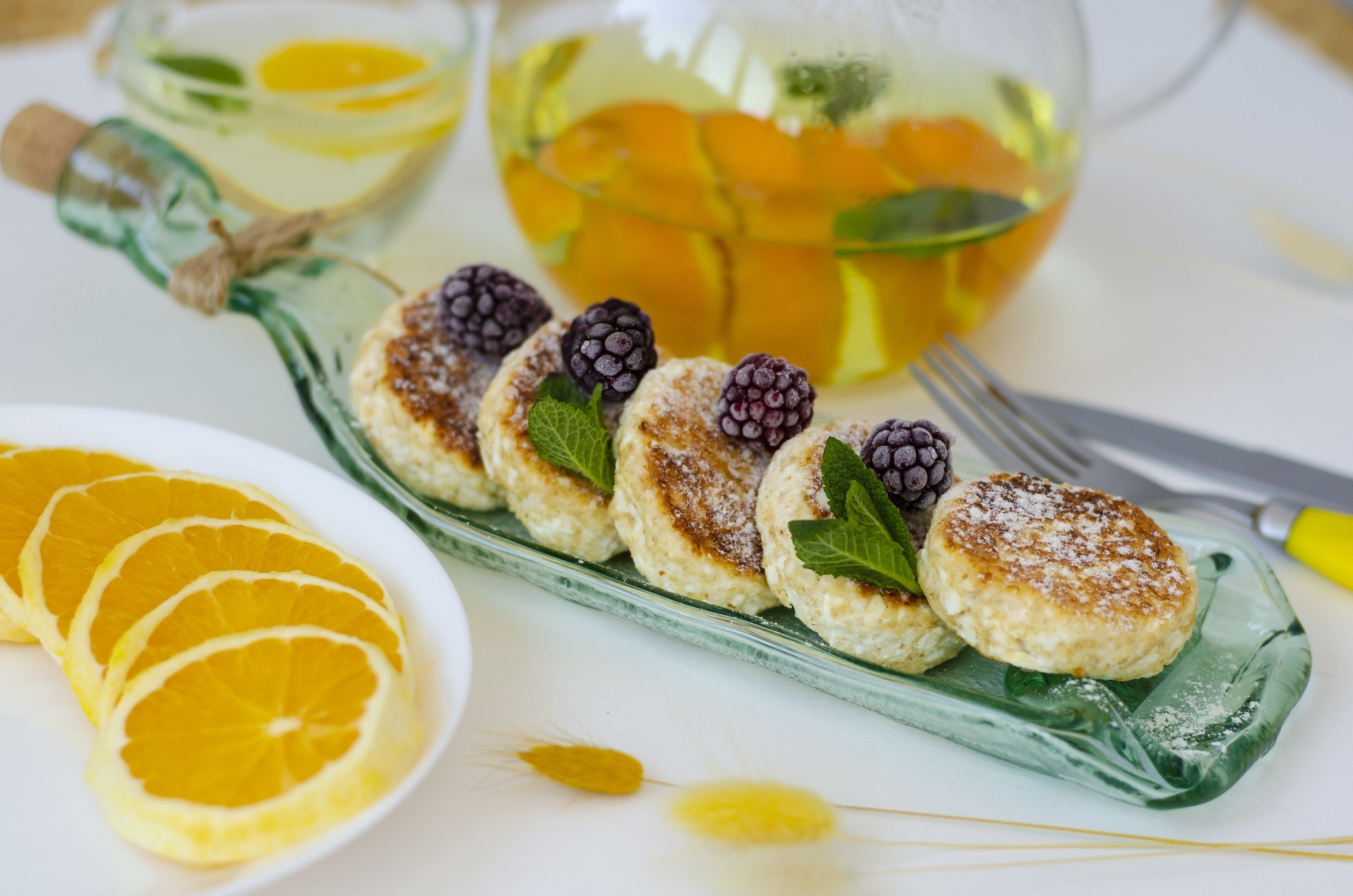 Syrniki with berries and orange slices HD Wallpaper