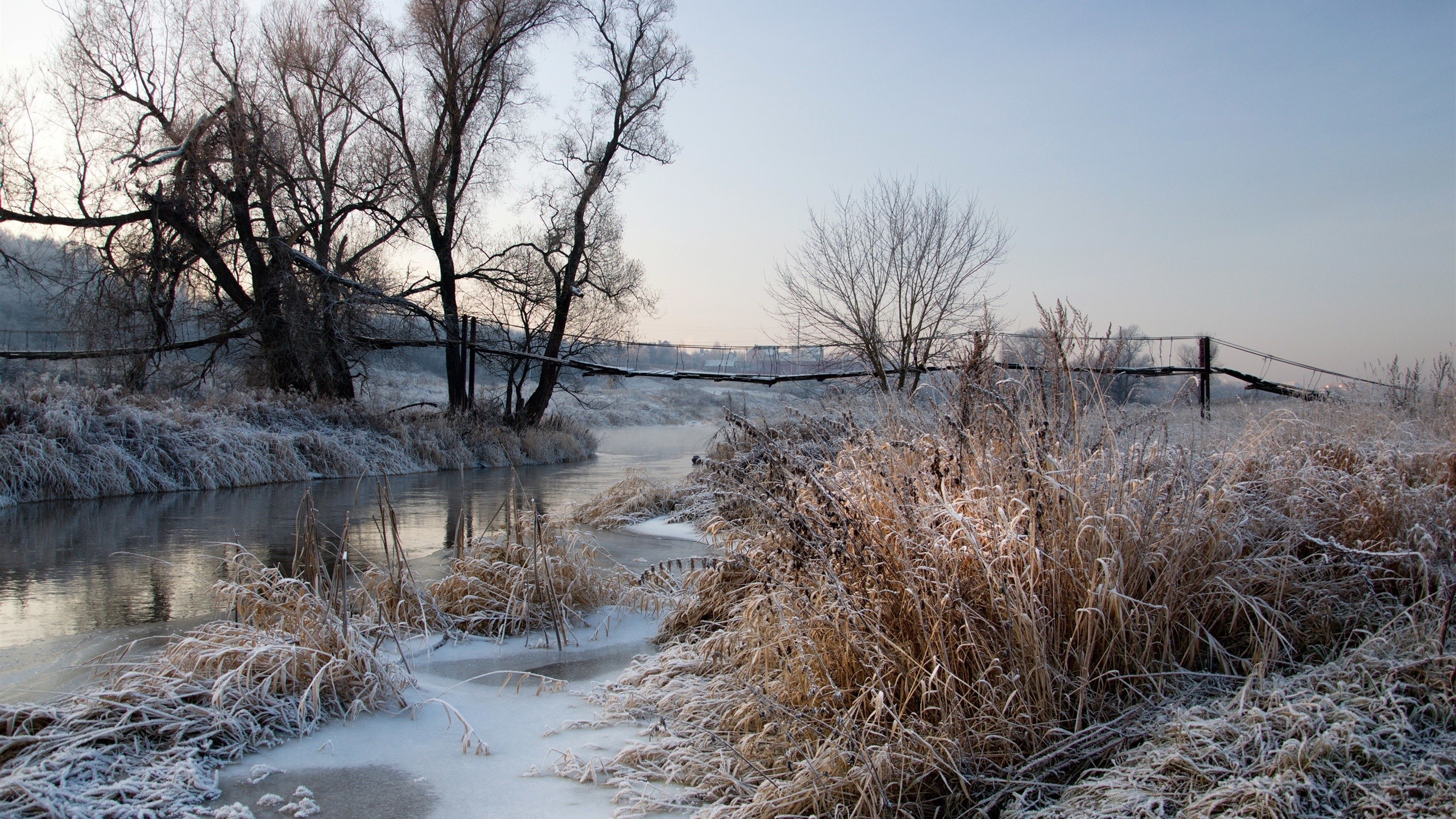 Frozen river and bridge in winter landscape HD Wallpaper