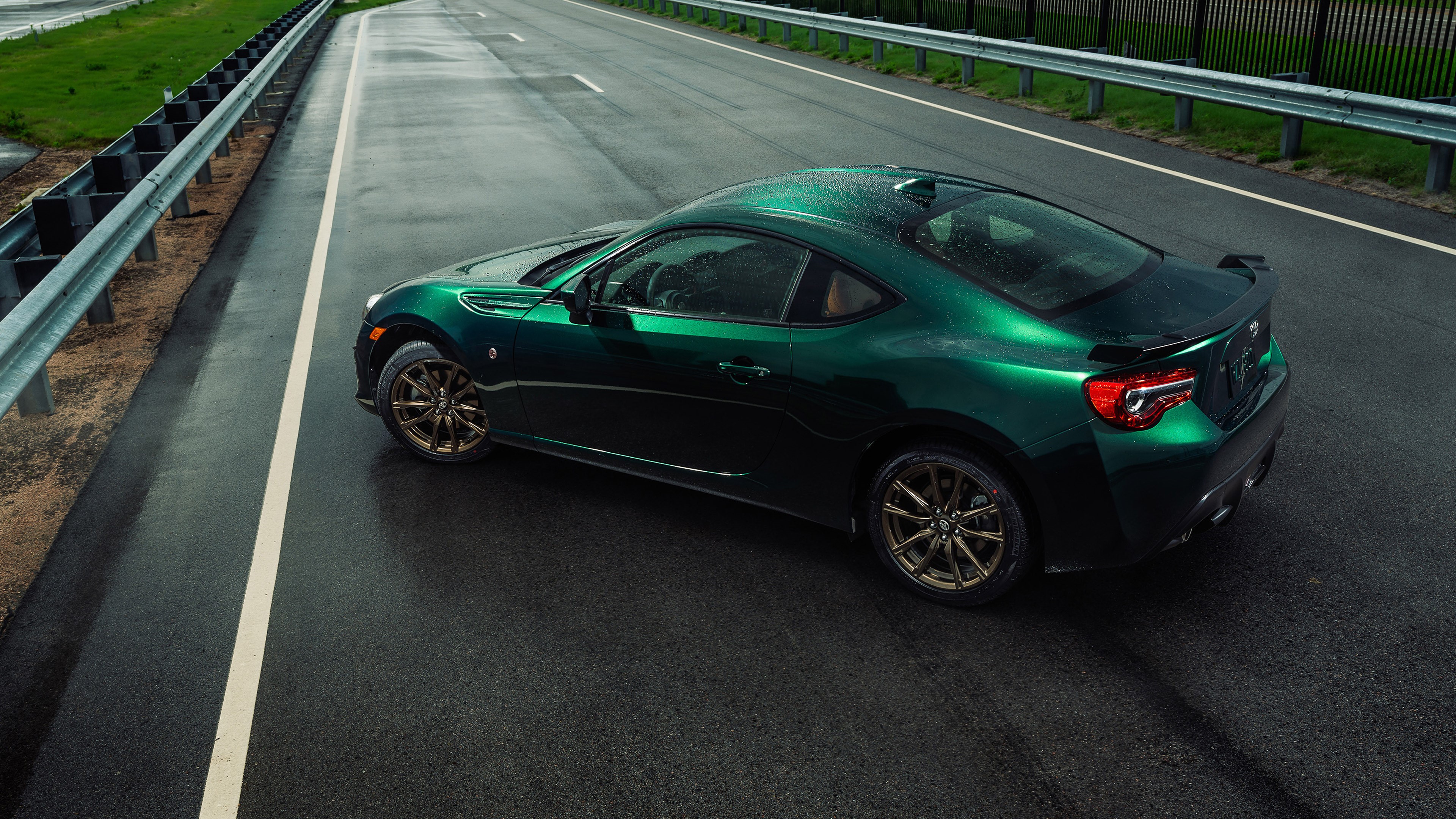 Green Toyota GT86 with colored wheels on a wet road HD Wallpaper